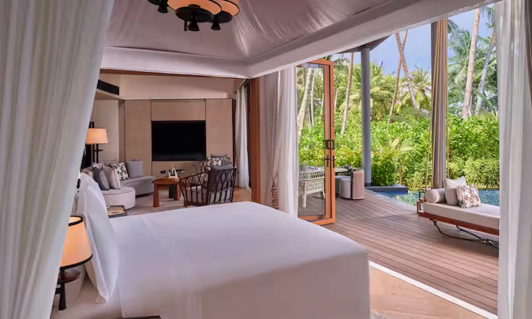 waldorf astoria seychelles one bedroom hawksbill garden pool villa bed with view of pool and garden