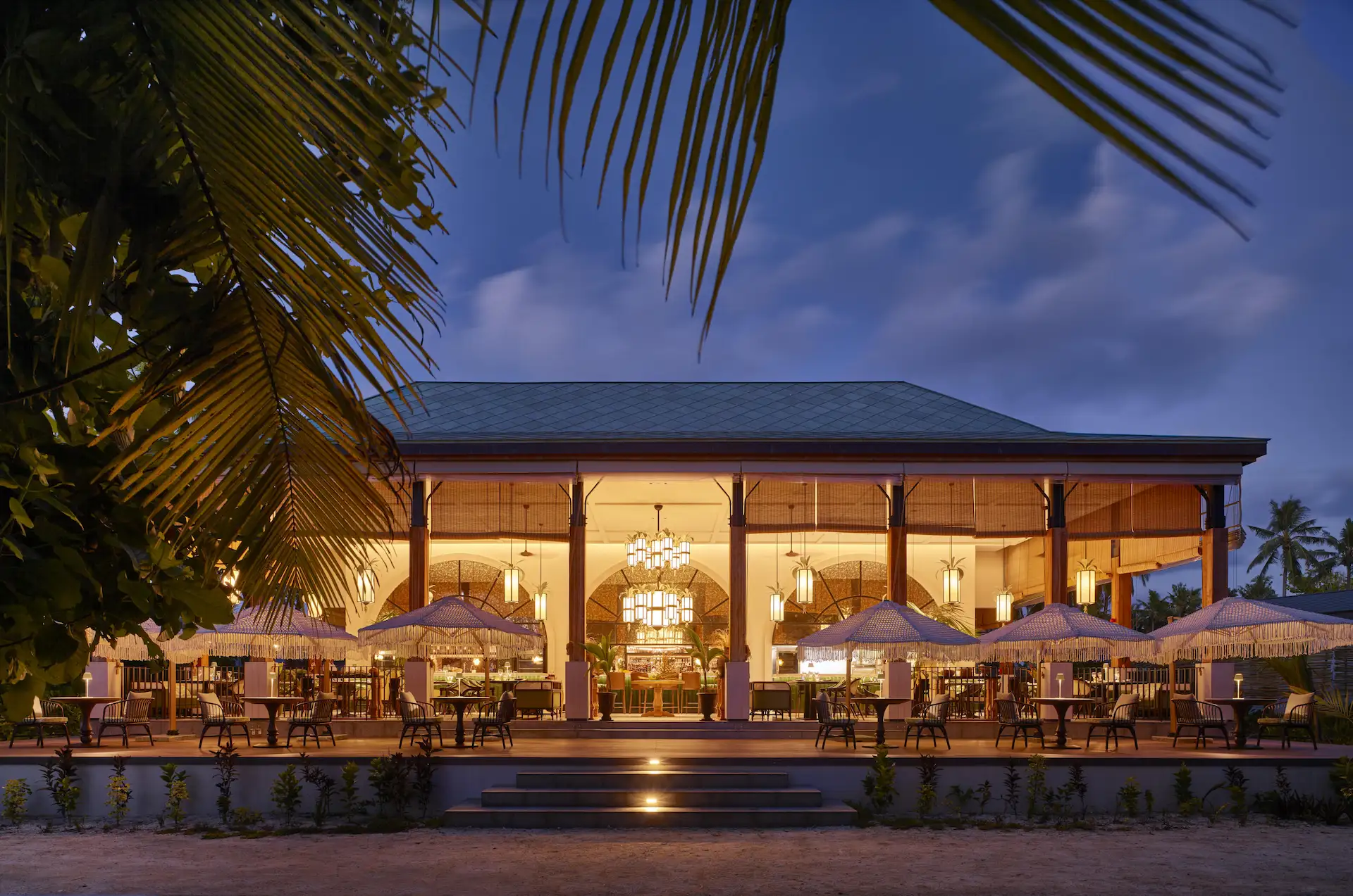 waldorf astoria seychelles platte island maison des epices restaurant with dining tables and tropical surroundings