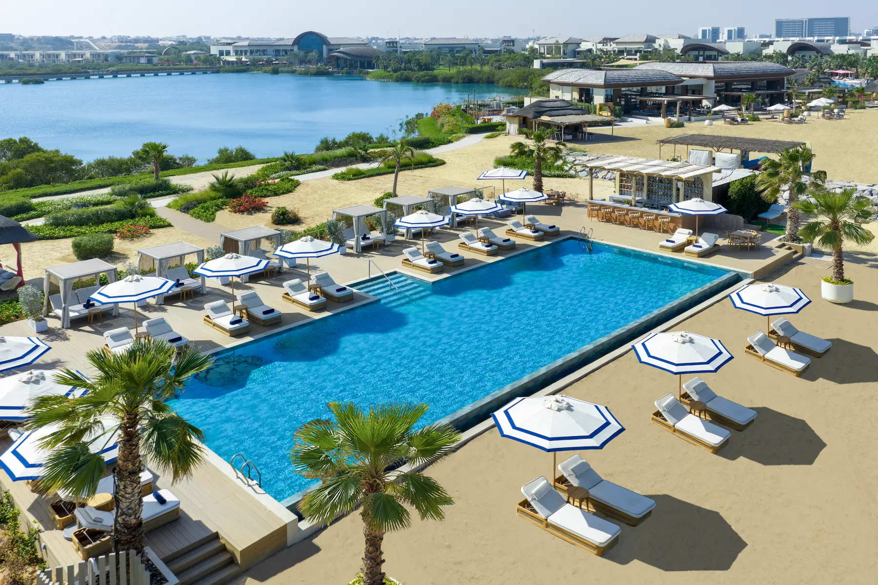 anantara mina ras al khaimah aerial view adult pool showcasing an elevated perspective of the adults only pool set within the resort beachfront surroundings