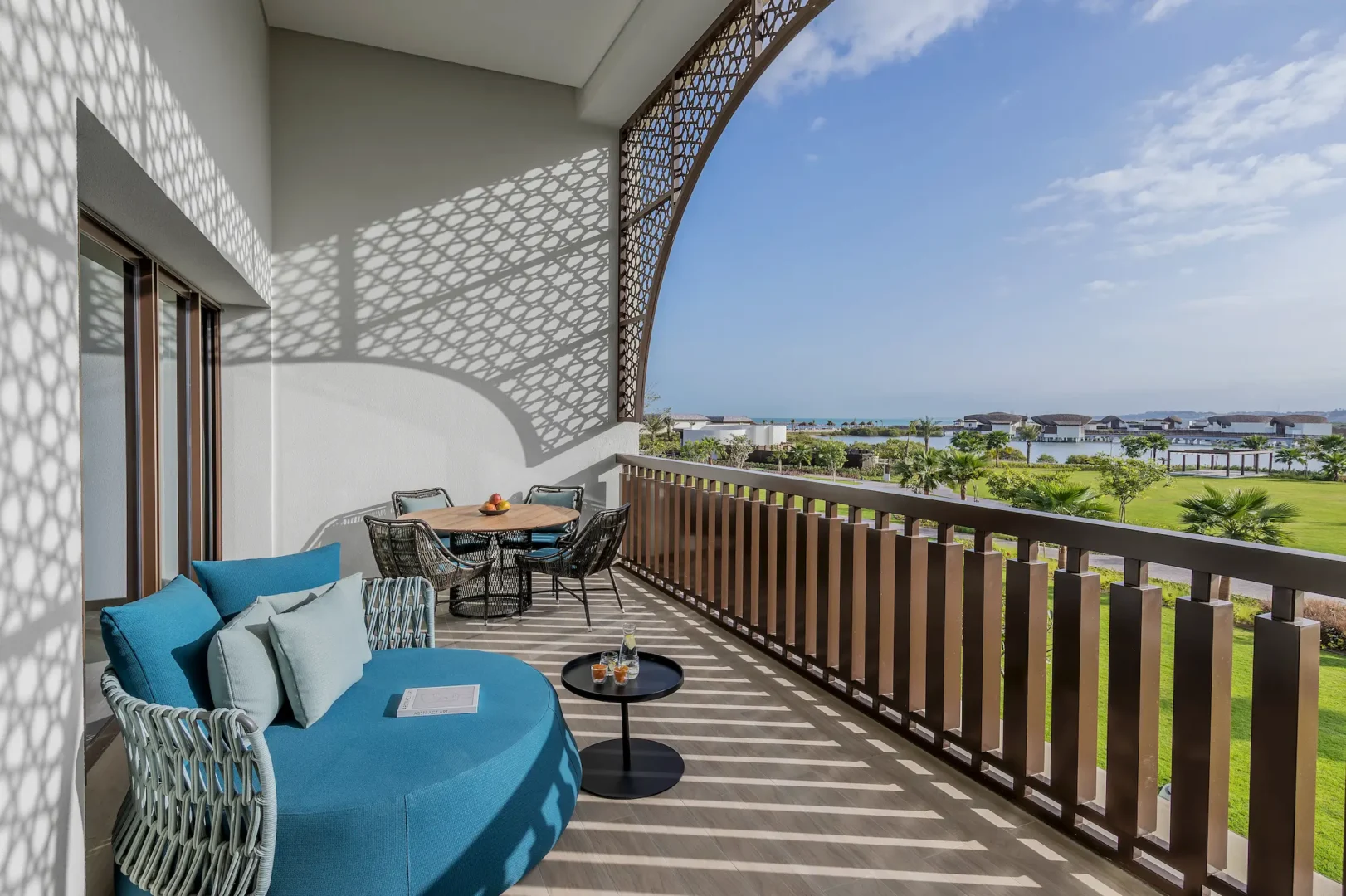 anantara mina ras al khaimah deluxe suite balcony view featuring a private outdoor balcony overlooking the serene resort surroundings