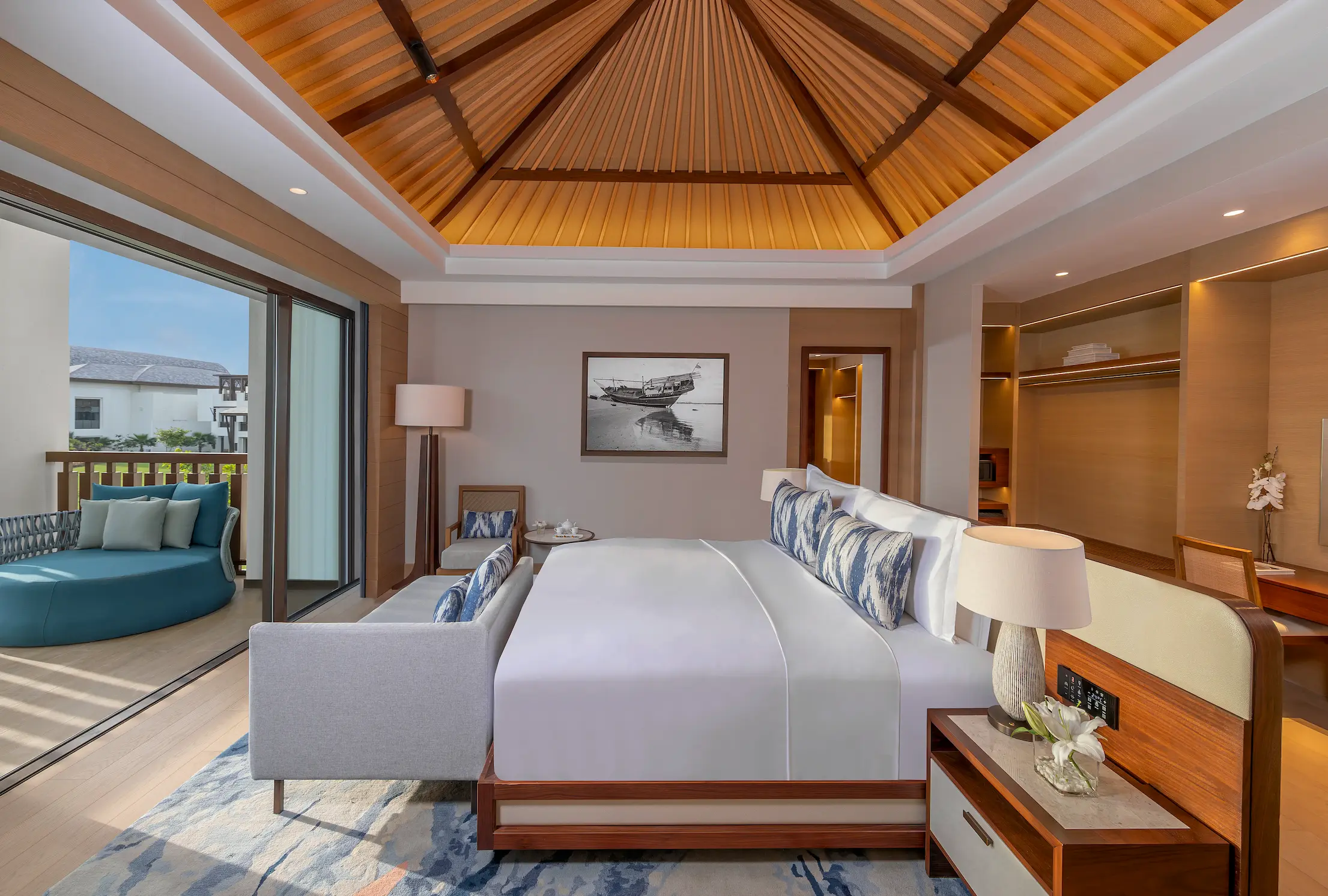anantara mina ras al khaimah deluxe suite bedroom featuring an elegant king bedroom with refined furnishings and a tranquil coastal aesthetic