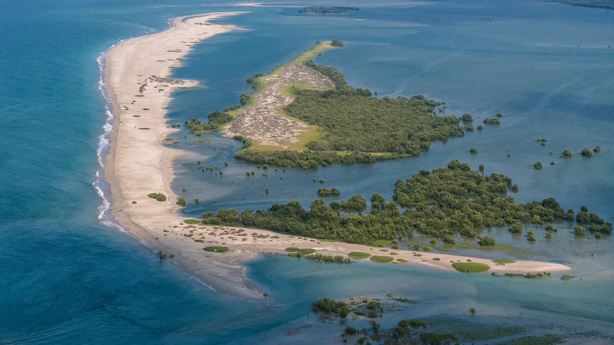 anantara mina ras al khaimah exterior view aerial mangroves beach showcasing the resort surrounded by lush mangroves and beachfront from an elevated perspective