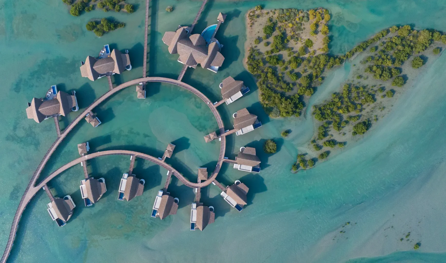 anantara mina ras al khaimah over water pool villa aerial showcasing an elevated view of the villa set above the lagoon with uninterrupted water surrounds