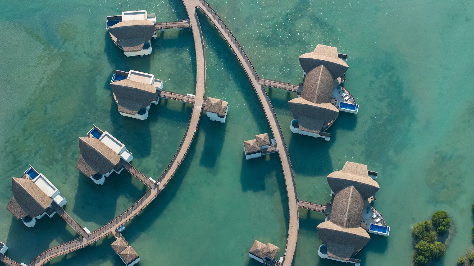 anantara mina ras al khaimah over water pool villa aerial showcasing a detailed elevated view of the villa set above the lagoon with surrounding waters