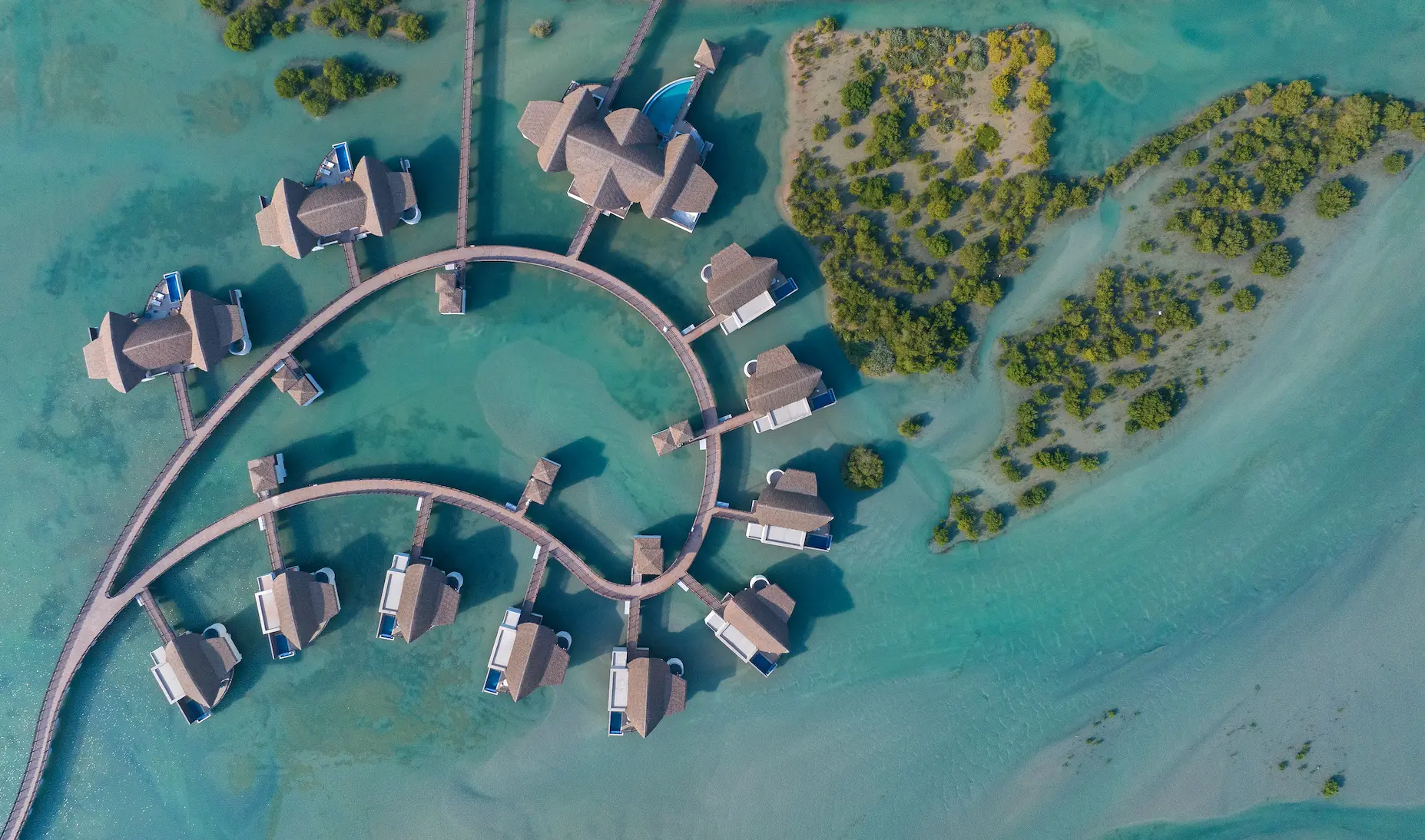 anantara mina ras al khaimah over water pool villa aerial showcasing an elevated view of the villa set above the lagoon with uninterrupted water surrounds