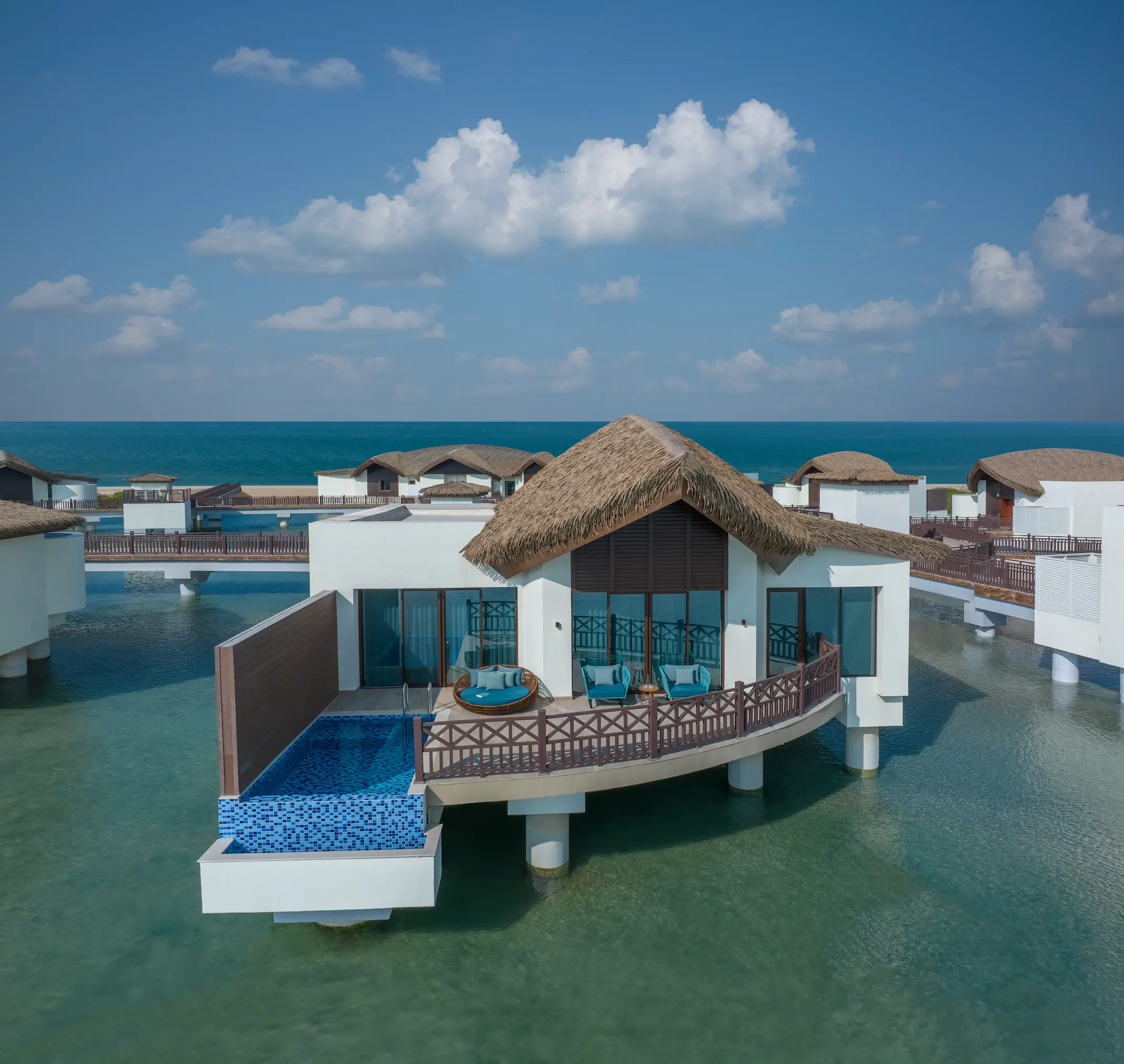 anantara mina ras al khaimah over water pool villa exterior showcasing the villa set above the lagoon in clear daylight with uninterrupted water surroundings