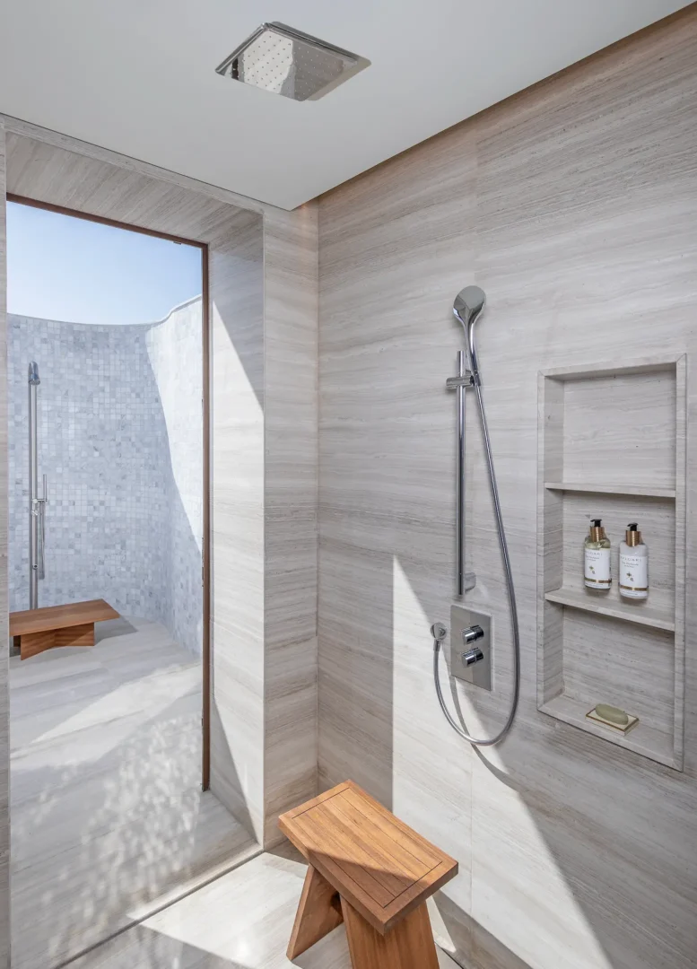 anantara mina ras al khaimah peninsula sea view pool villa shower featuring a refined indoor shower space designed with elegant finishes and a serene coastal aesthetic