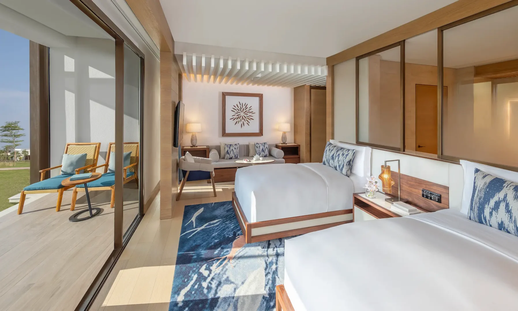 anantara mina ras al khaimah premier garden terrace room bedroom featuring a spacious twin bedroom with elegant furnishings and a calm garden inspired setting