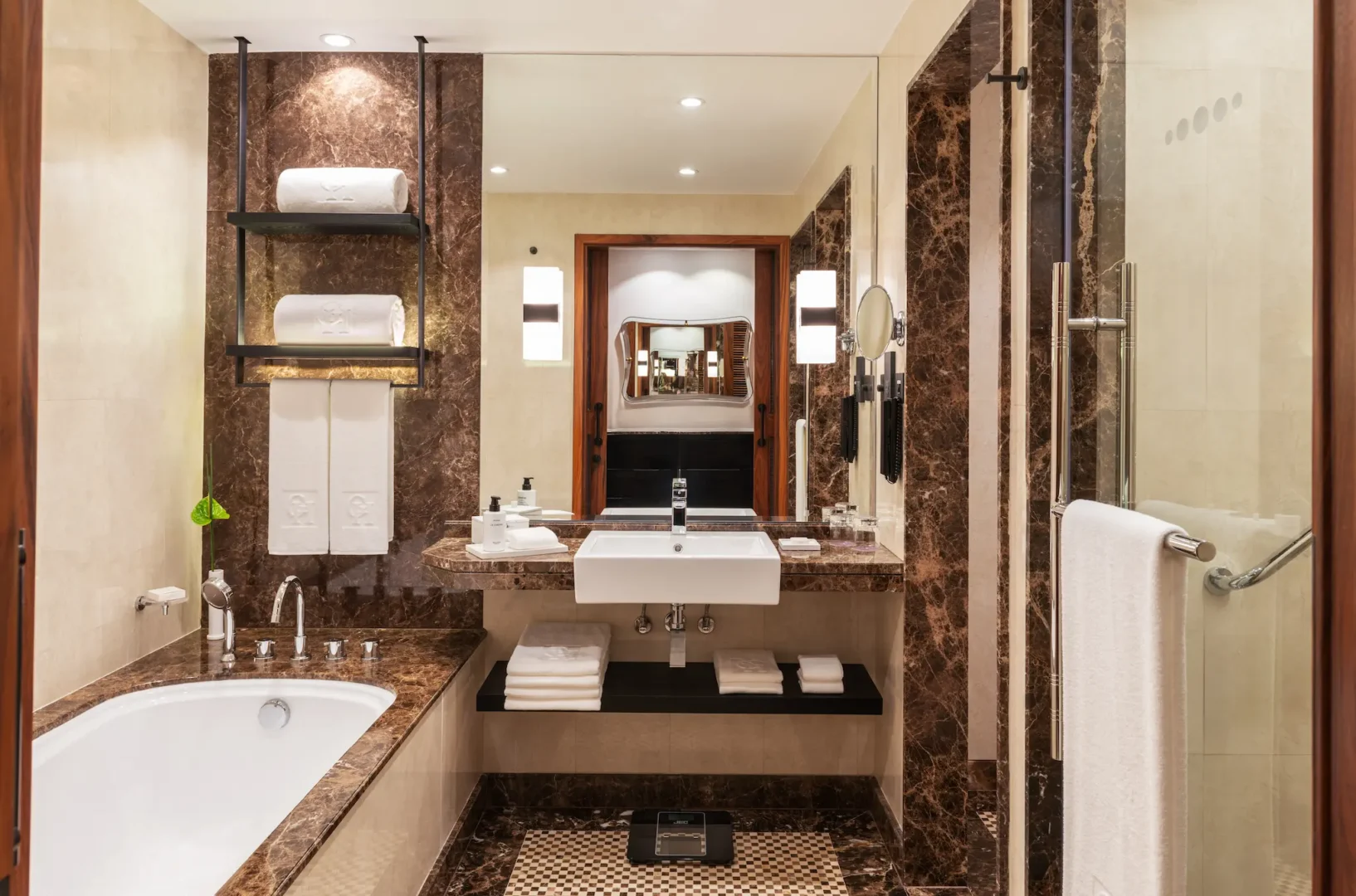 grosvenor house dubai deluxe room twin bed bathroom with elegant marble finishes and luxury amenities
