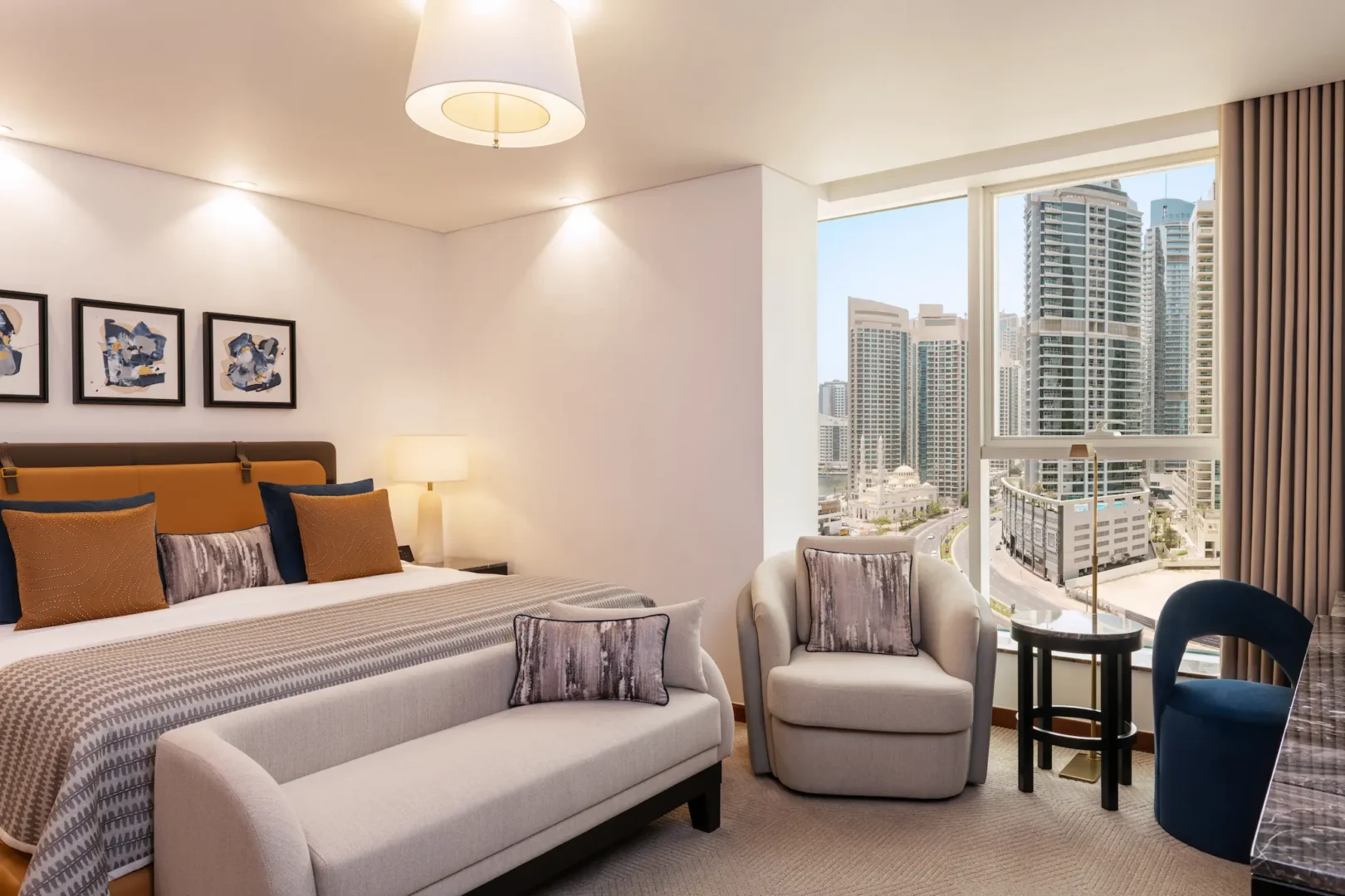 grosvenor house dubai deluxe suite king bed featuring refined luxury finishes and elegant contemporary styling