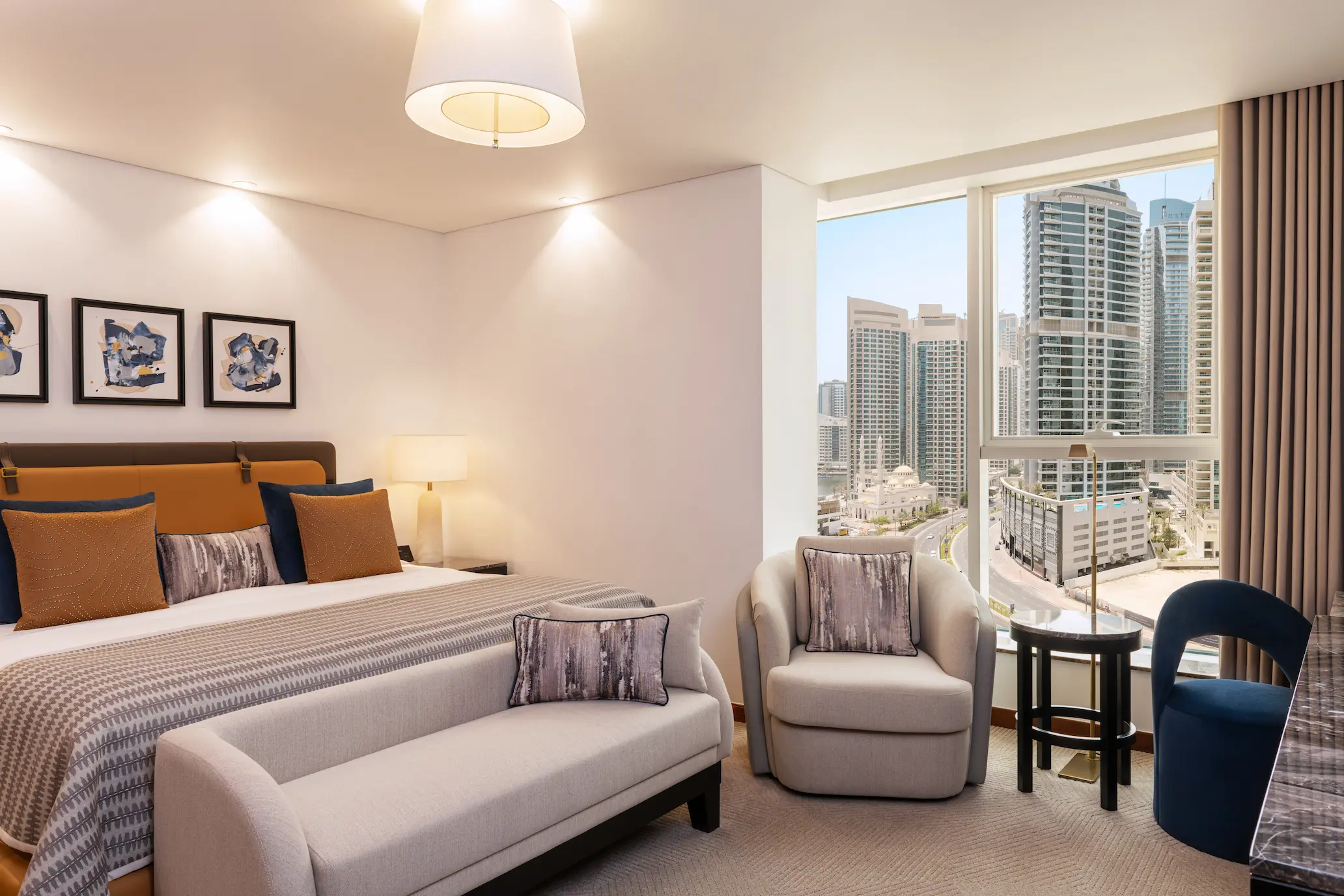 grosvenor house dubai deluxe suite king bed featuring refined luxury finishes and elegant contemporary styling