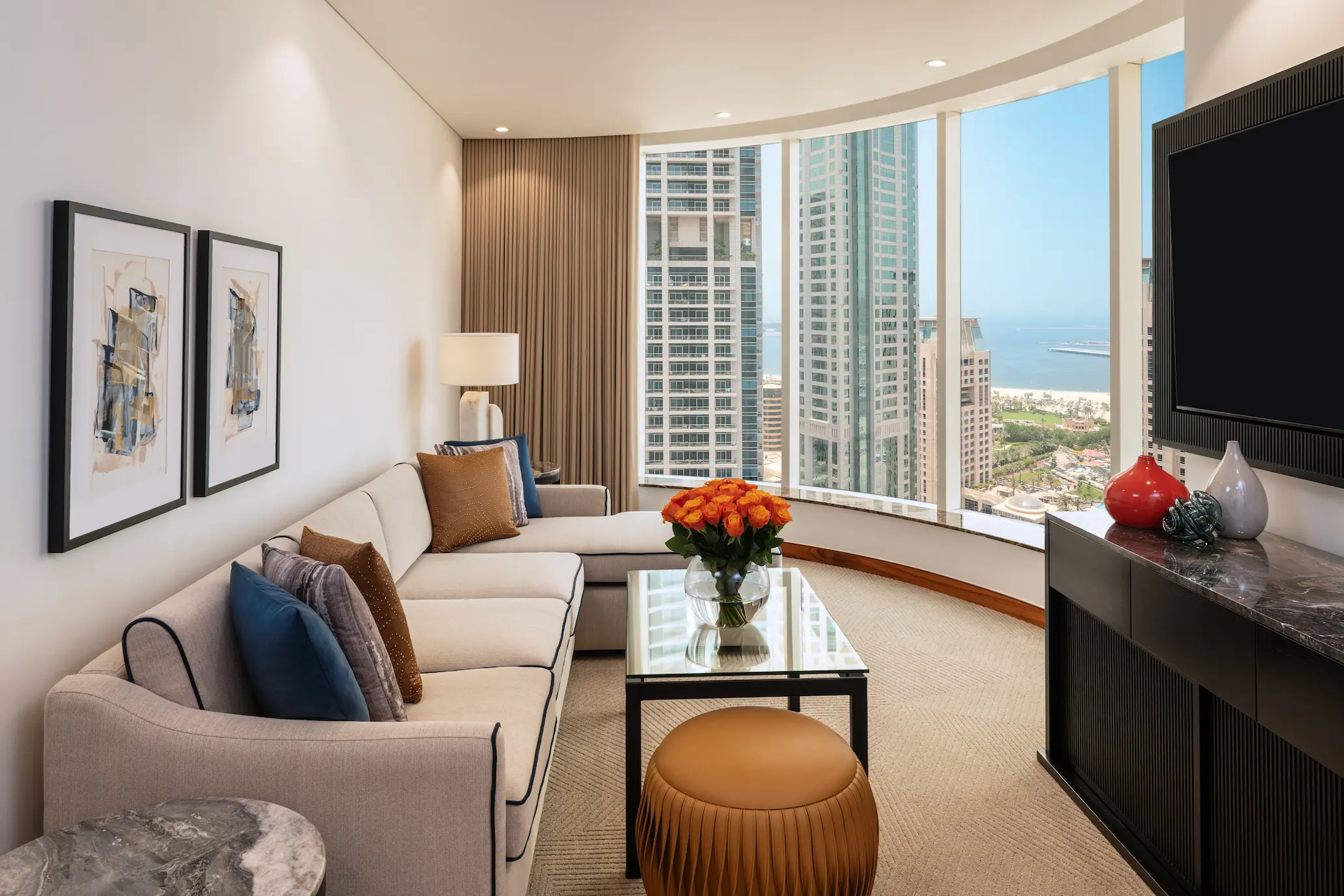 grosvenor house dubai deluxe suite lounge area featuring refined luxury seating and an elegant relaxed atmosphere