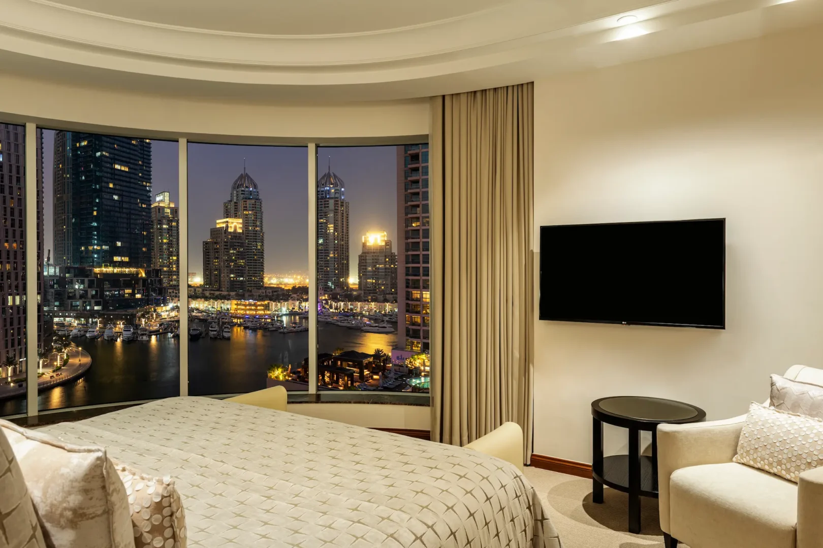 grosvenor house dubai premier suite bedroom night skyline view overlooking the illuminated cityscape
