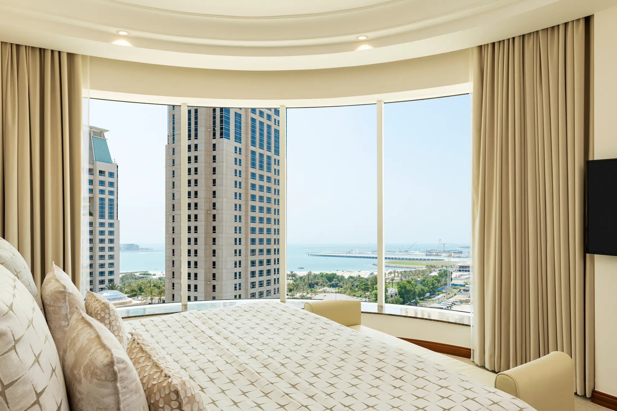 grosvenor house dubai premier suite king bed daylight view showcasing natural light and refined luxury styling