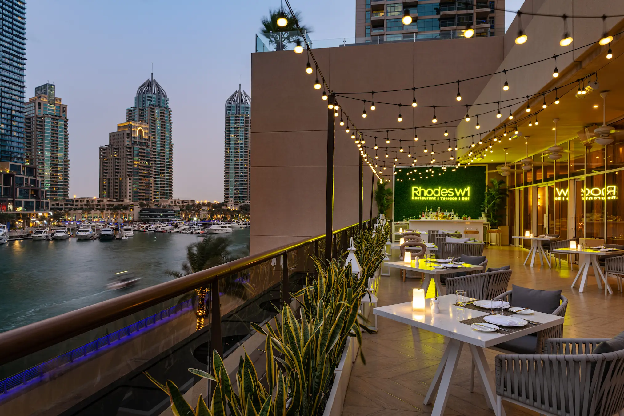 grosvenor house dubai rhodes wone outdoor area featuring an elegant alfresco dining setting and refined luxury atmosphere
