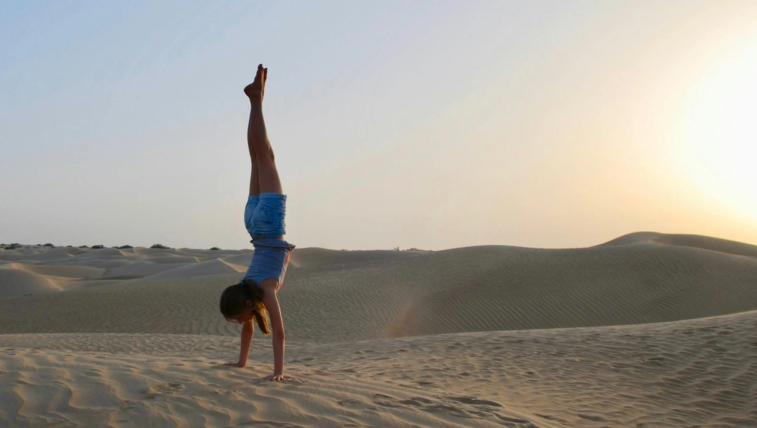 oman magic camp desert yoga experience set among serene desert dunes at sunrise