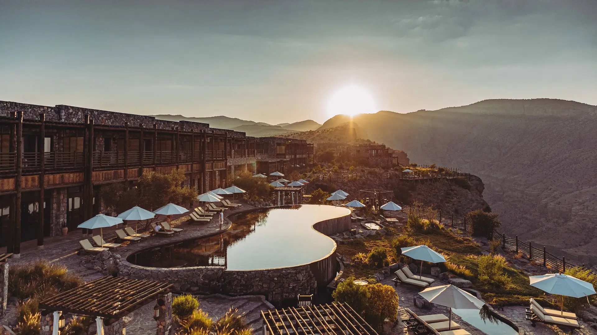 pool at sunset with mountain view at alila jabal akhdar oman