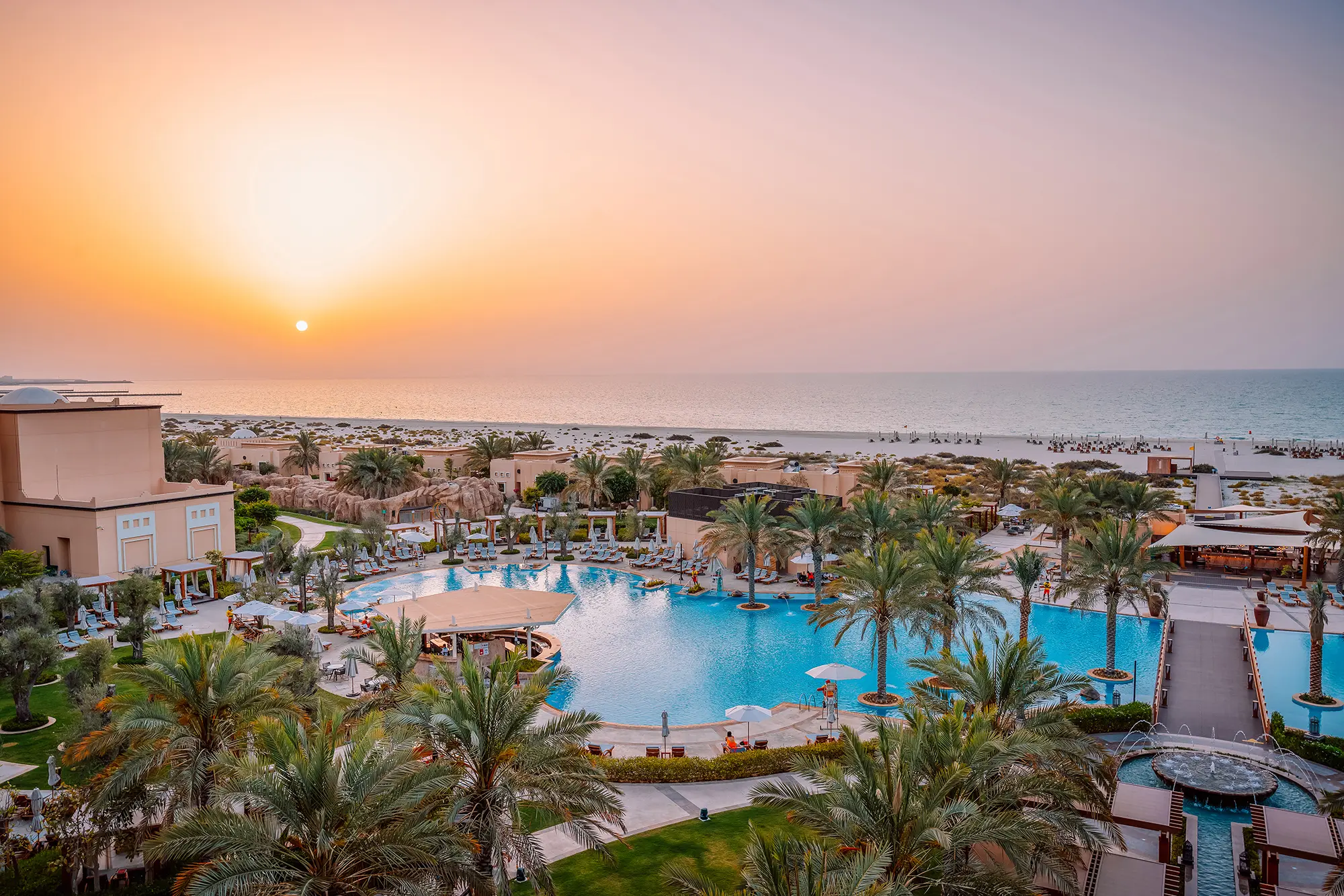 saadiyat rotana resort and villas abu dhabi hotel exterior at sunset