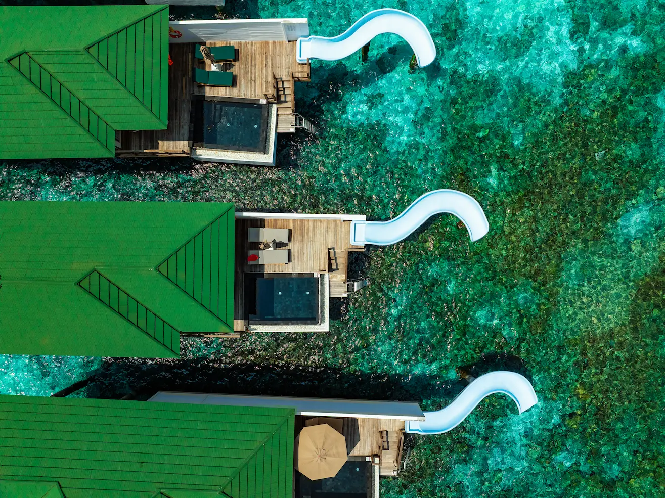 siyam world maldives lagoon villa with pool slide aerial view showcasing private overwater luxury