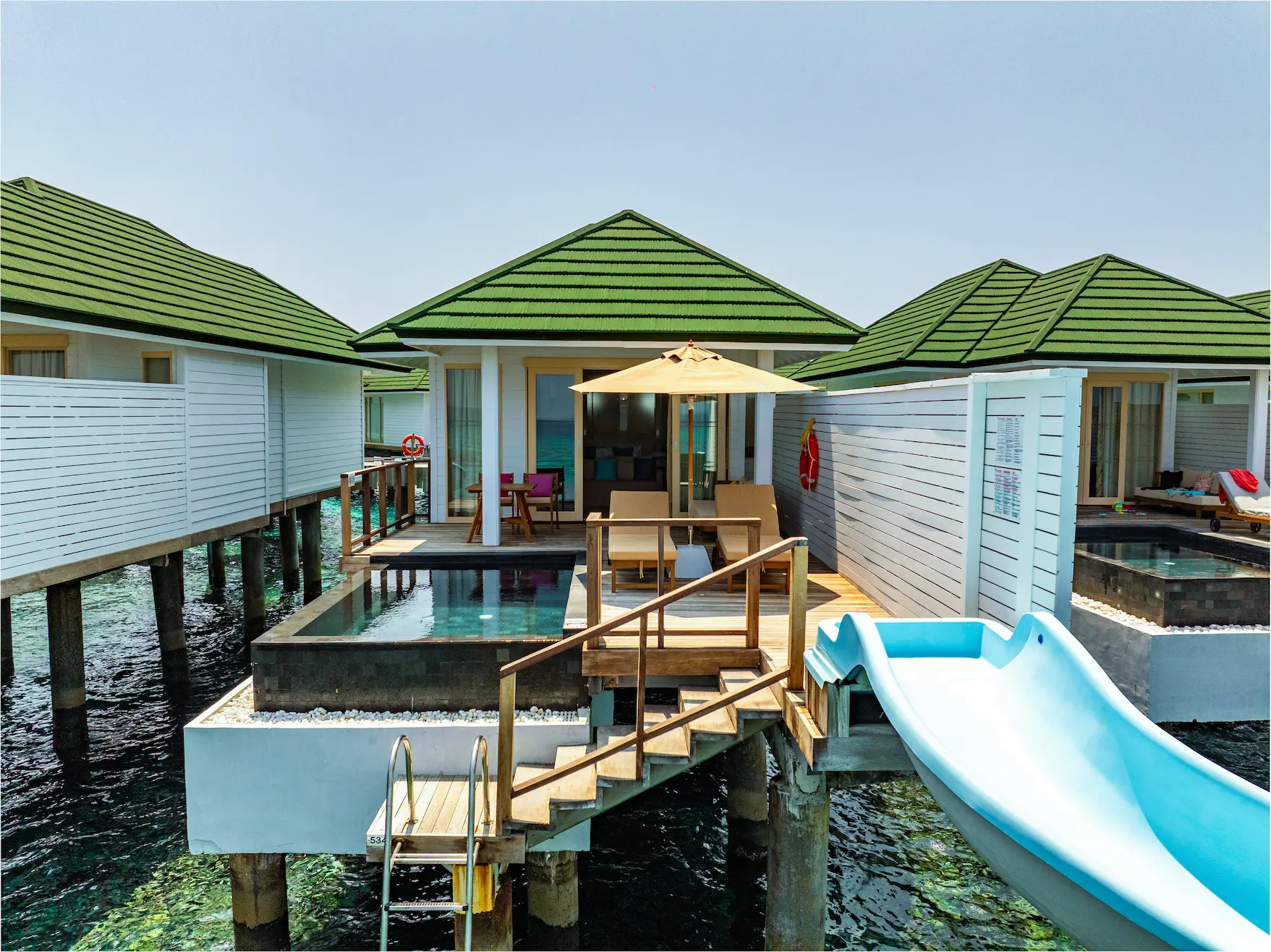 siyam world maldives lagoon villa with pool slide exterior highlighting private overwater luxury