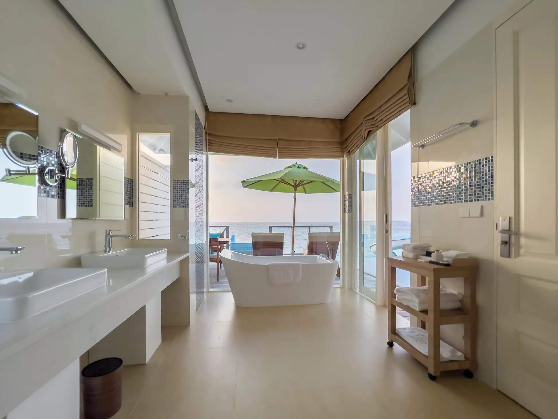 siyam world maldives ocean villa with pool slide bathroom featuring refined overwater luxury