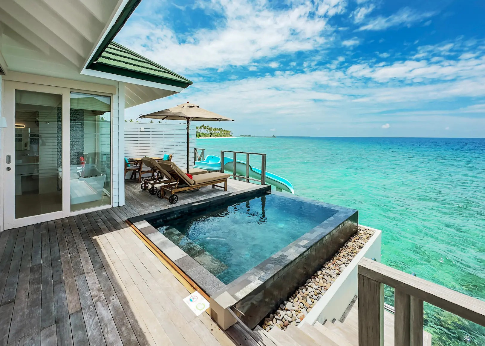 siyam world maldives ocean villa with pool slide view showcasing elevated overwater luxury