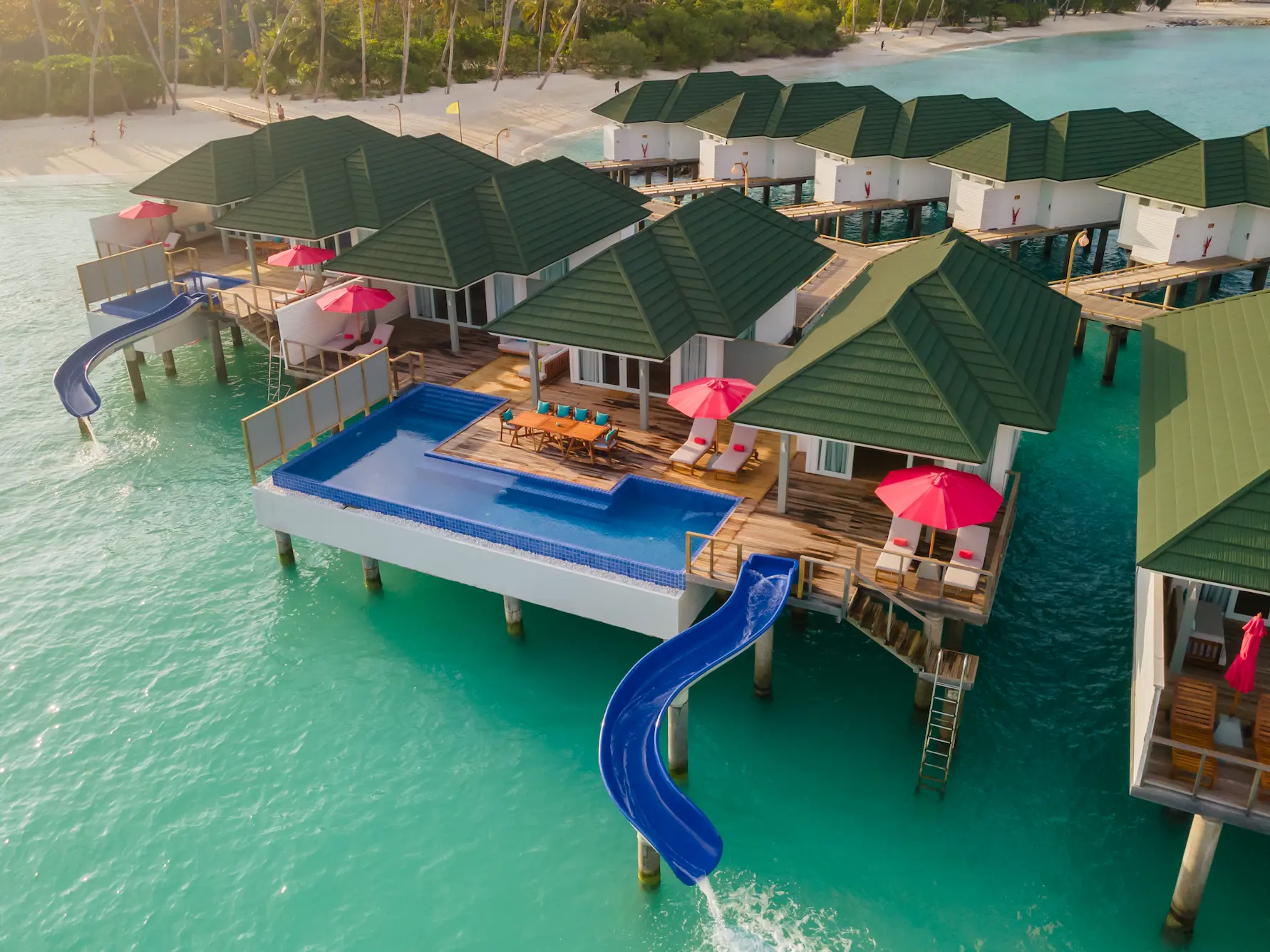 siyam world maldives three bedroom lagoon villa with pool slide aerial view showcasing expansive overwater luxury