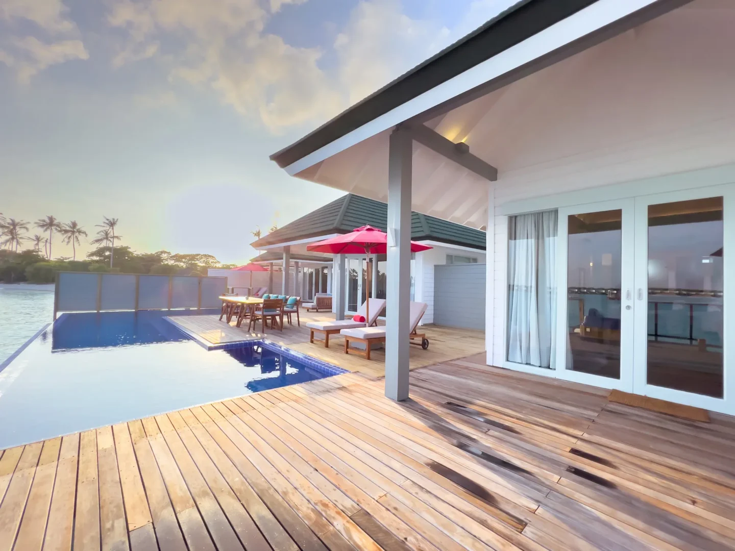 siyam world maldives three bedroom lagoon villa with pool slide deck offering spacious overwater luxury
