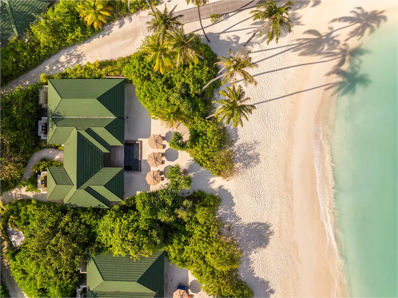 siyam world maldives three bedroom pool beach villa aerial view showcasing expansive beachfront luxury