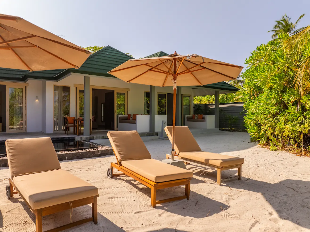 siyam world maldives three bedroom pool beach villa sunbed offering relaxed beachfront luxury