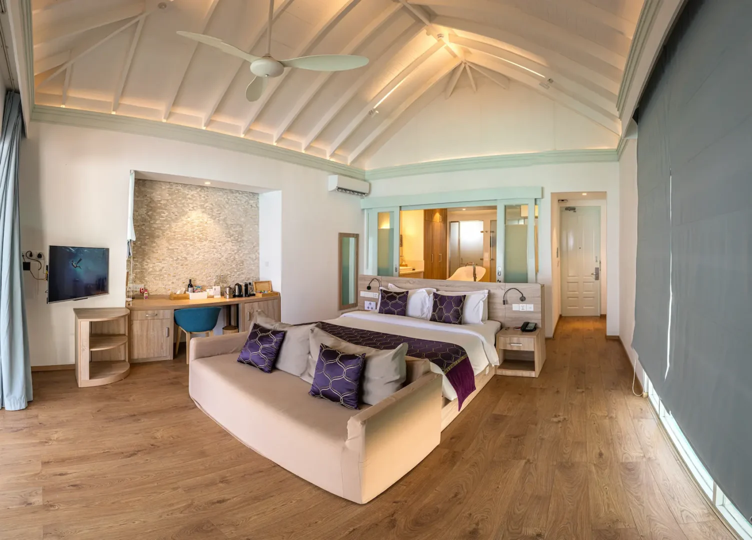 siyam world maldives two bedroom lagoon villa with pool slide bedroom offering serene overwater luxury interior