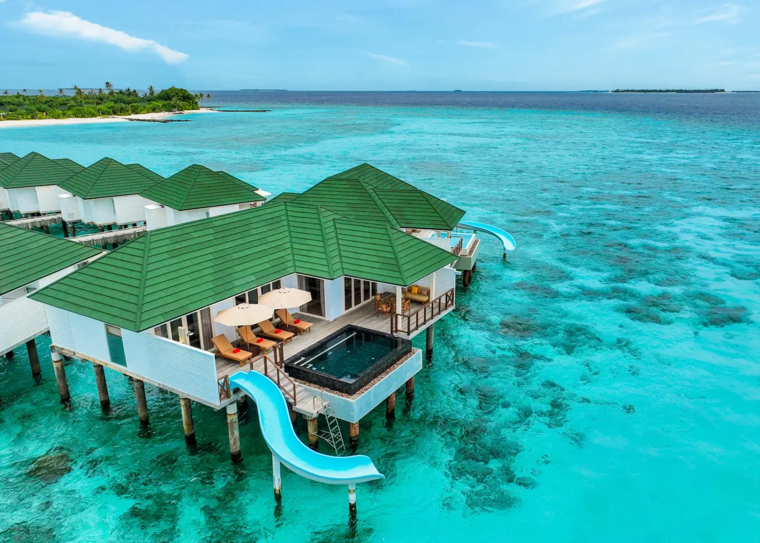 siyam world maldives water pavilion with pool slide exterior showcasing elevated overwater luxury