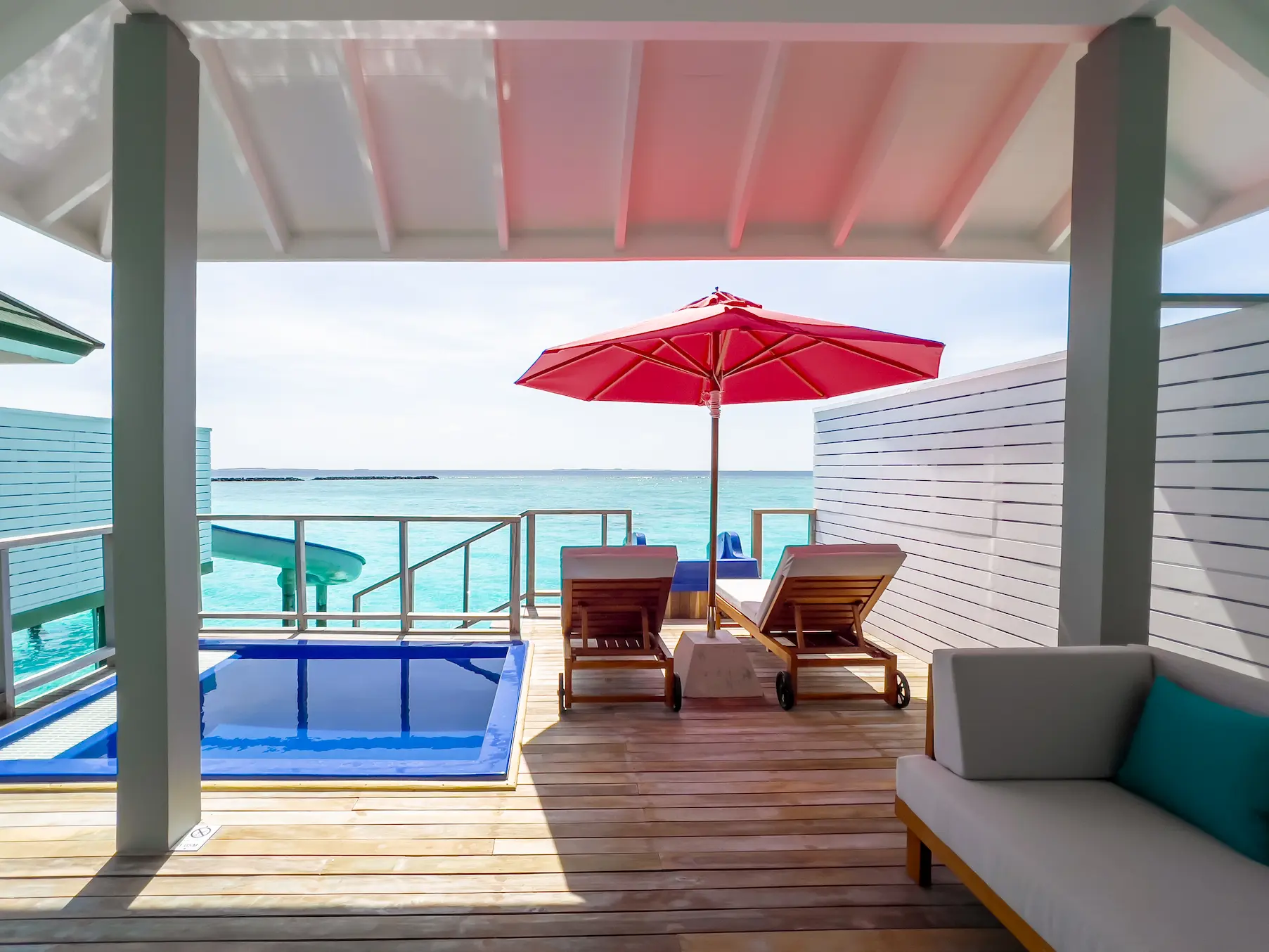 siyam world maldives water villa with pool slide terrace showcasing overwater luxury and panoramic ocean views