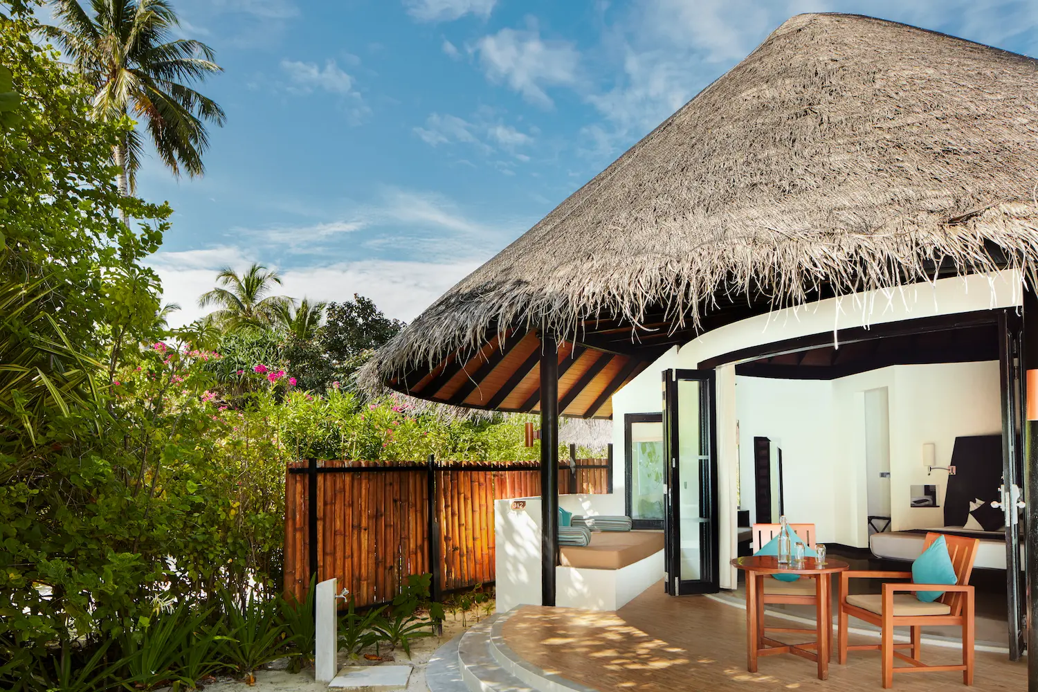 luxury deluxe beach villa exterior at sun siyam iru fushi maldives beachfront accommodation