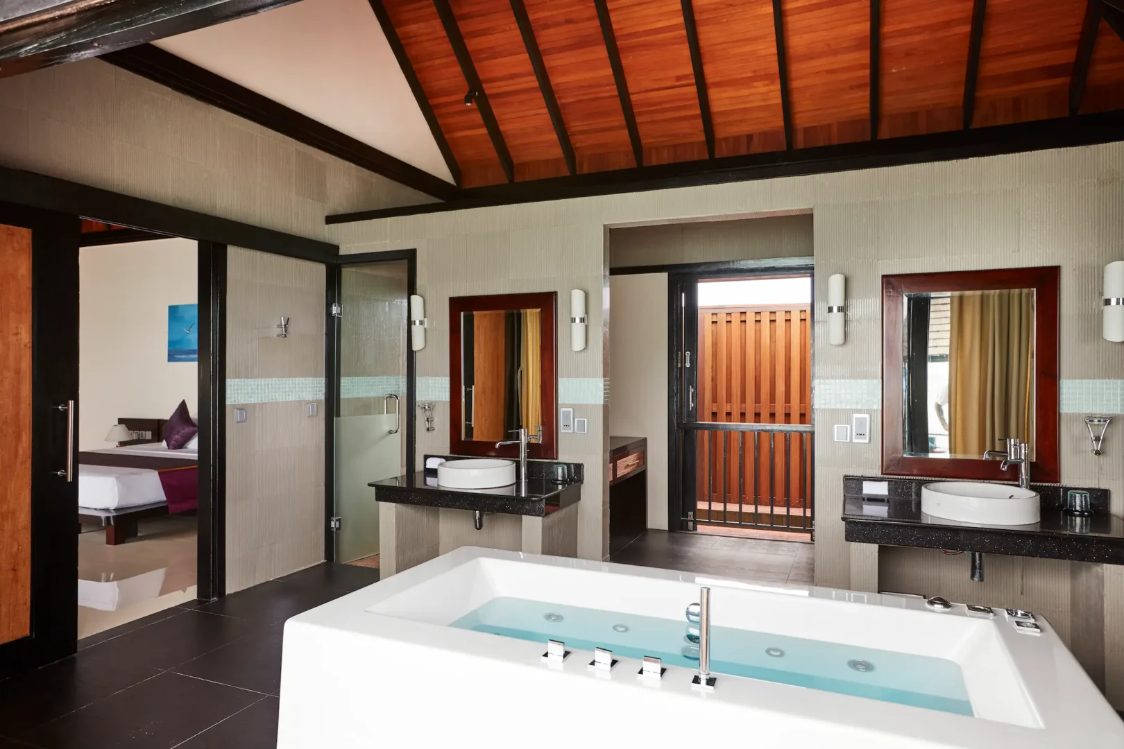 luxury infinity water villa bathroom at sun siyam iru fushi maldives overwater accommodation