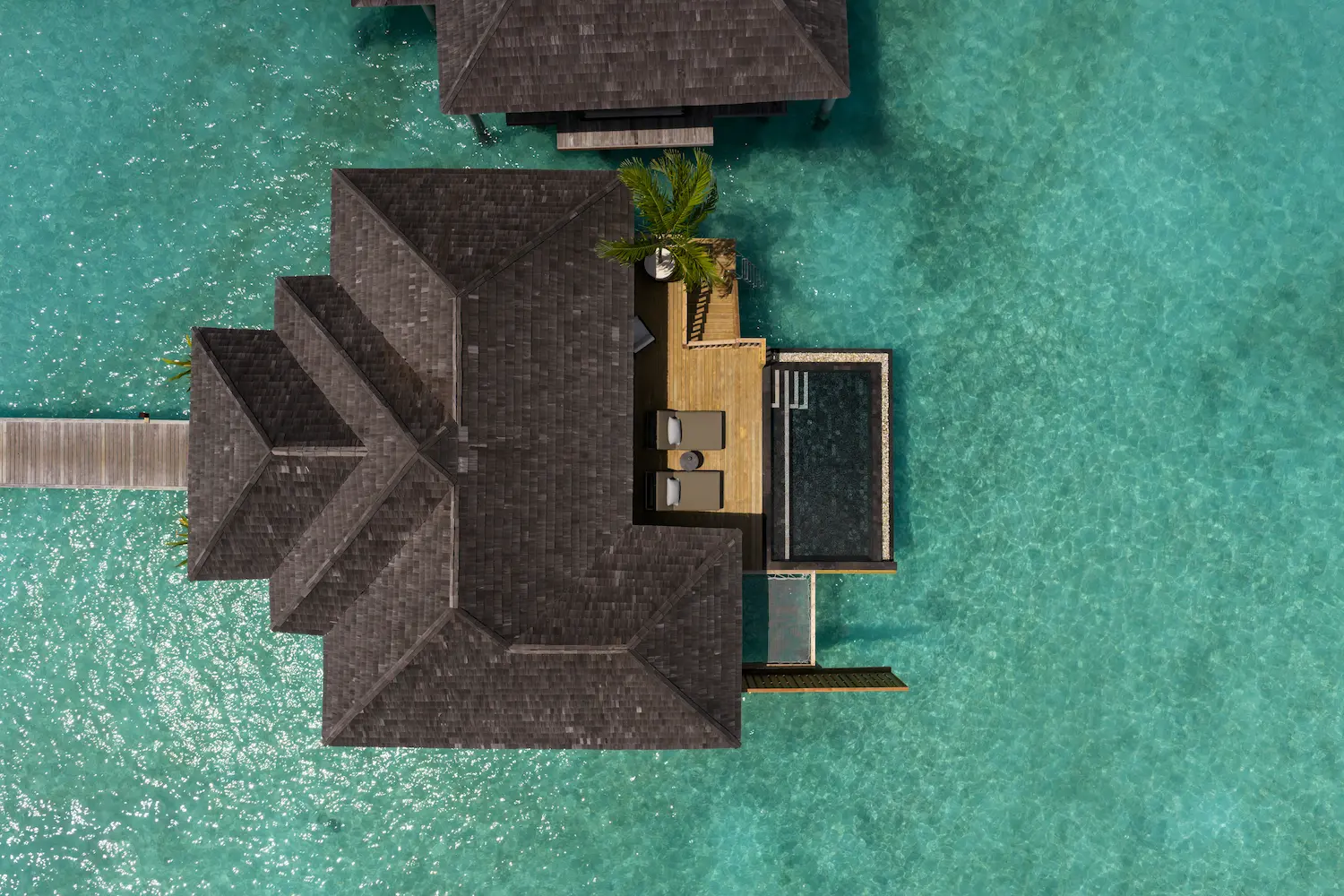 luxury water villa with pool aerial view at sun siyam iru fushi maldives overwater accommodation