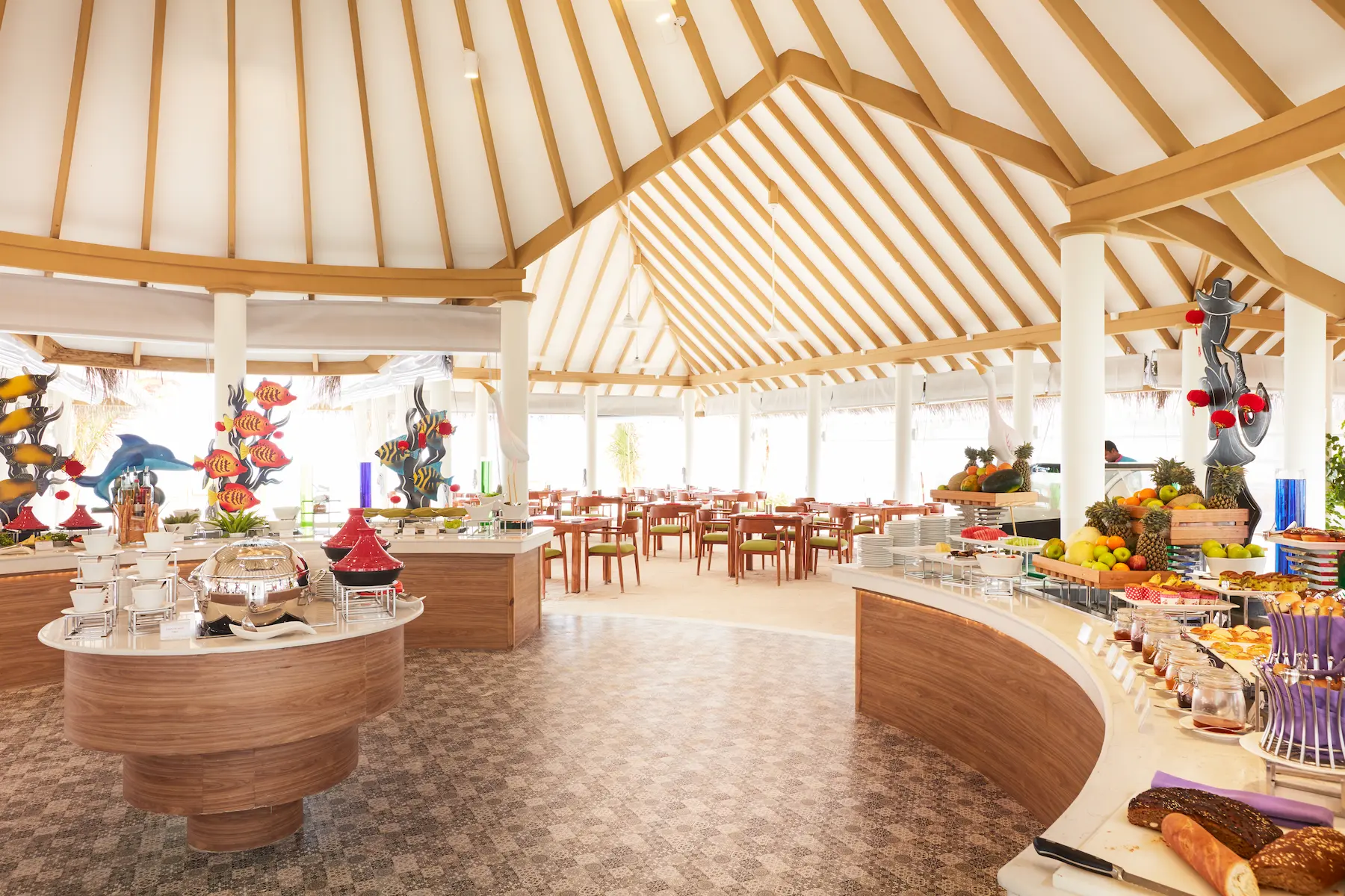 sun siyam iru veli maldives aqua orange showcasing a vibrant beachfront dining ambience with ocean views