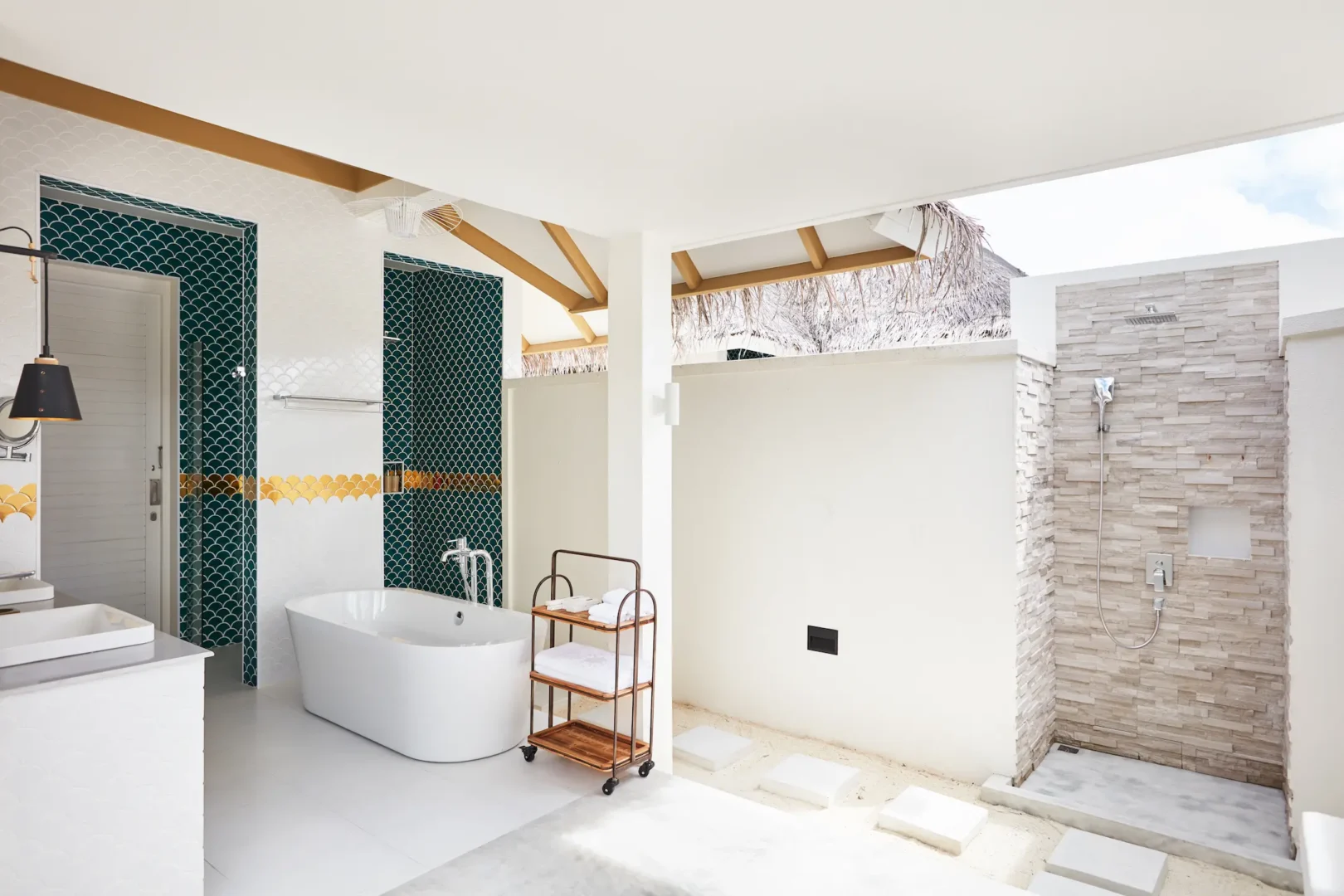 sun siyam iru veli maldives family beach villa with pool bathroom featuring spacious layout natural stone finishes and open air island design
