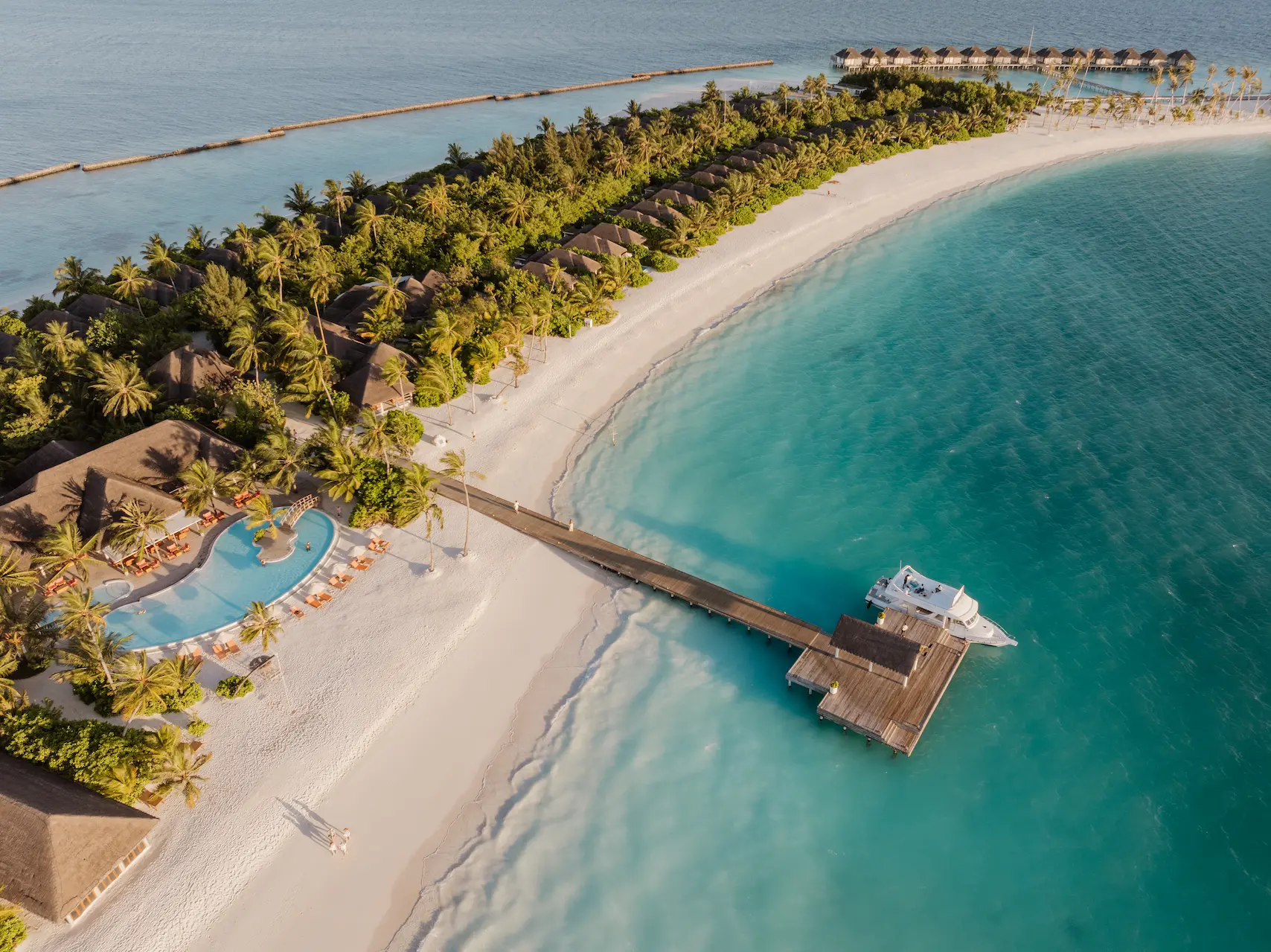 sun siyam iru veli maldives island aerial showcasing turquoise lagoon white sand beaches and overwater villas