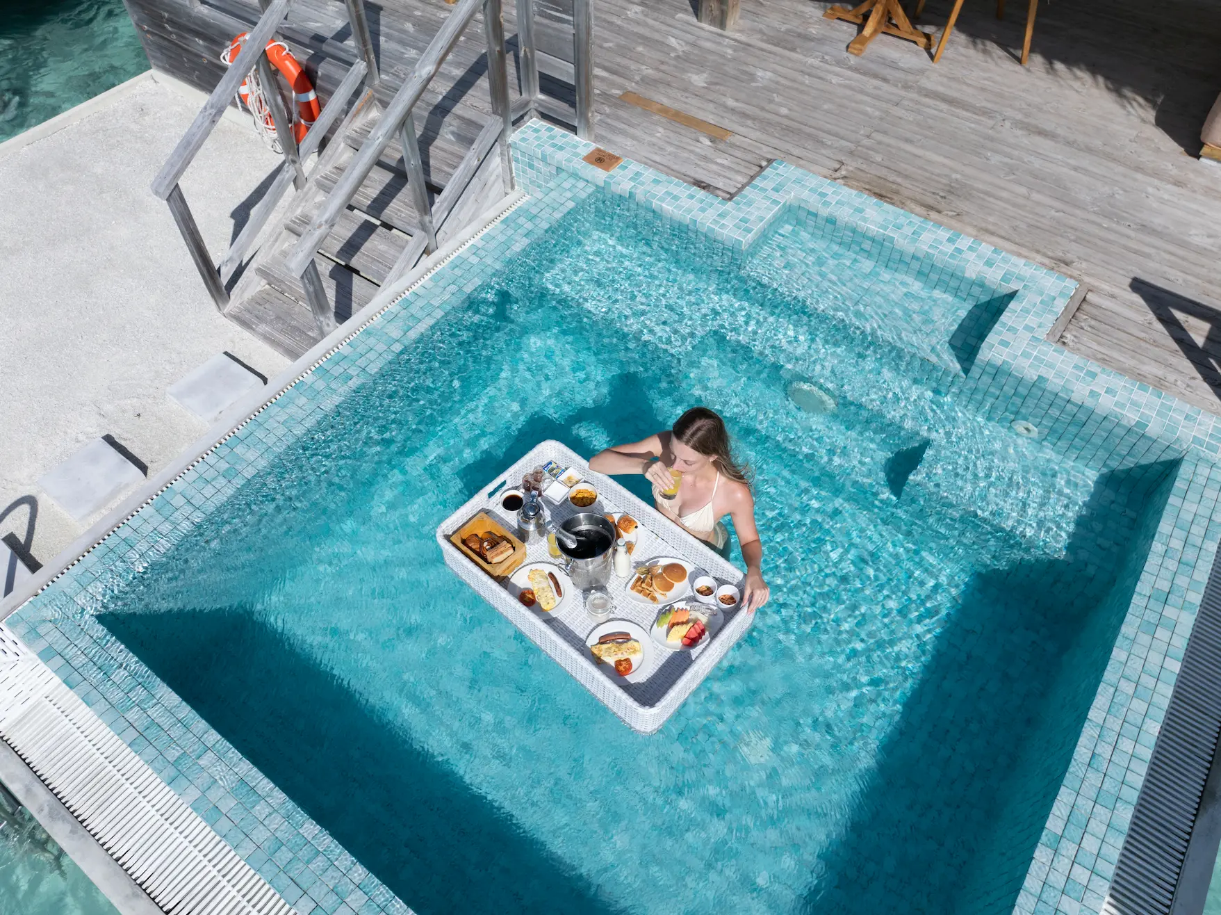 sun siyam iru veli maldives pierro floating breakfast showcasing a relaxed luxury breakfast experience served in a private pool