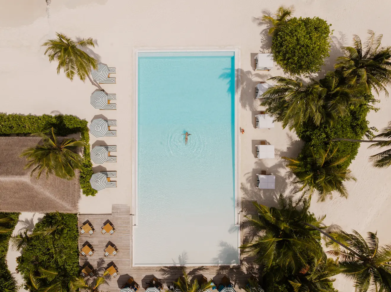 sun siyam iru veli maldives thomas collection pool party showcasing a vibrant social atmosphere with music drinks and a lively poolside setting