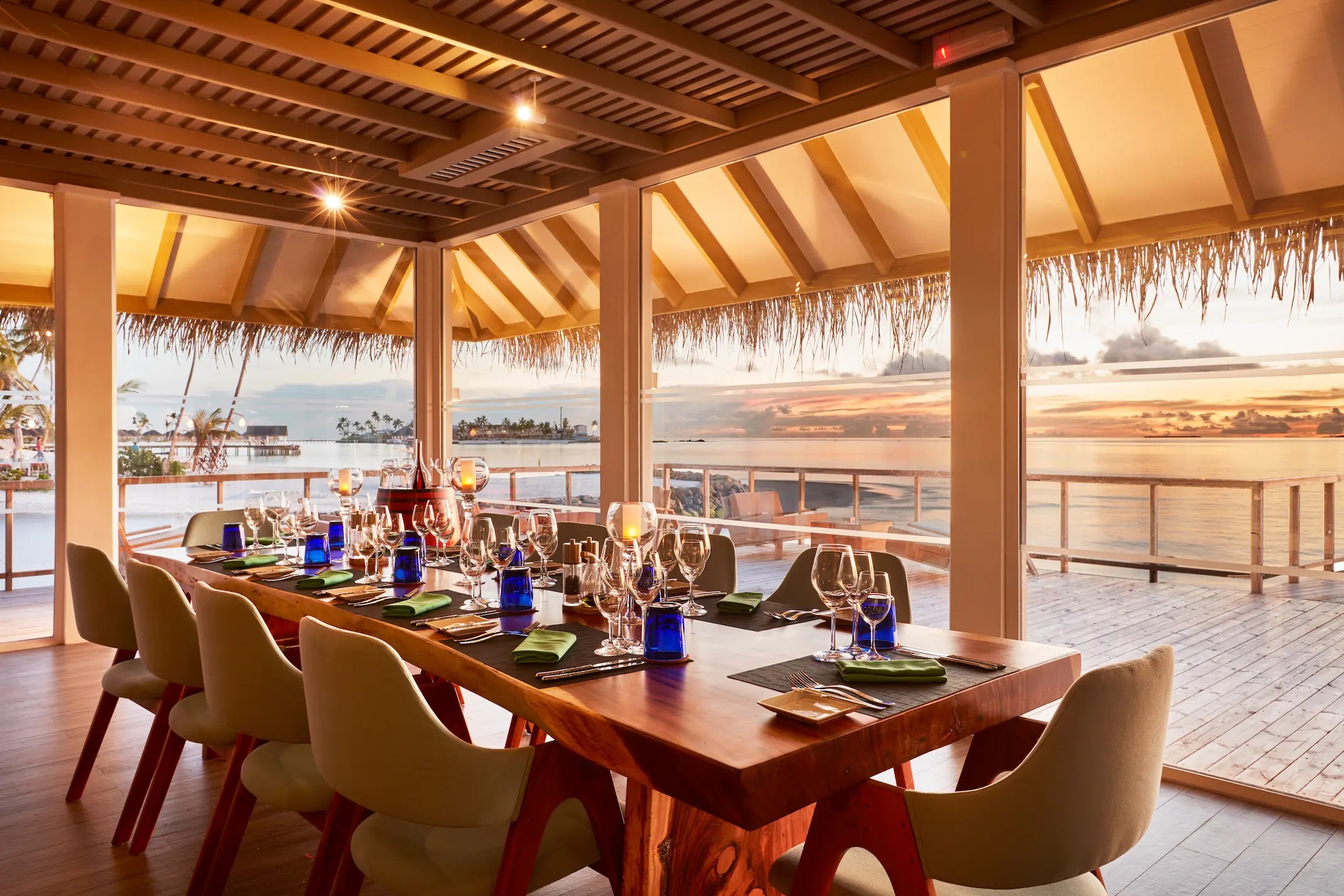 sun siyam iru veli maldives wine cellar showcasing an intimate underground setting with curated wine displays and refined atmosphere