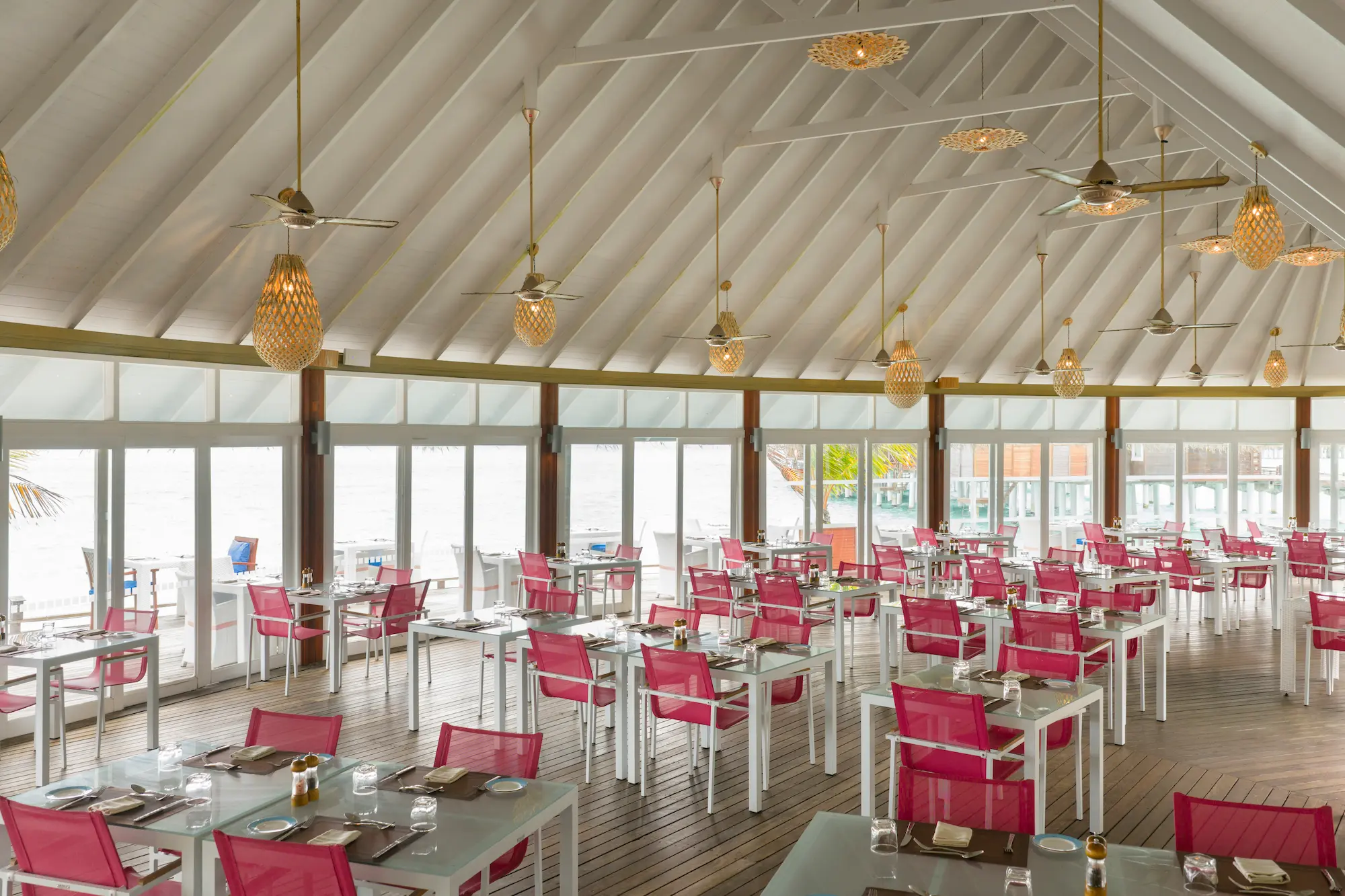 sun siyam vilu reef maldives aqua restaurant interior showcasing refined open air dining design with a relaxed tropical atmosphere