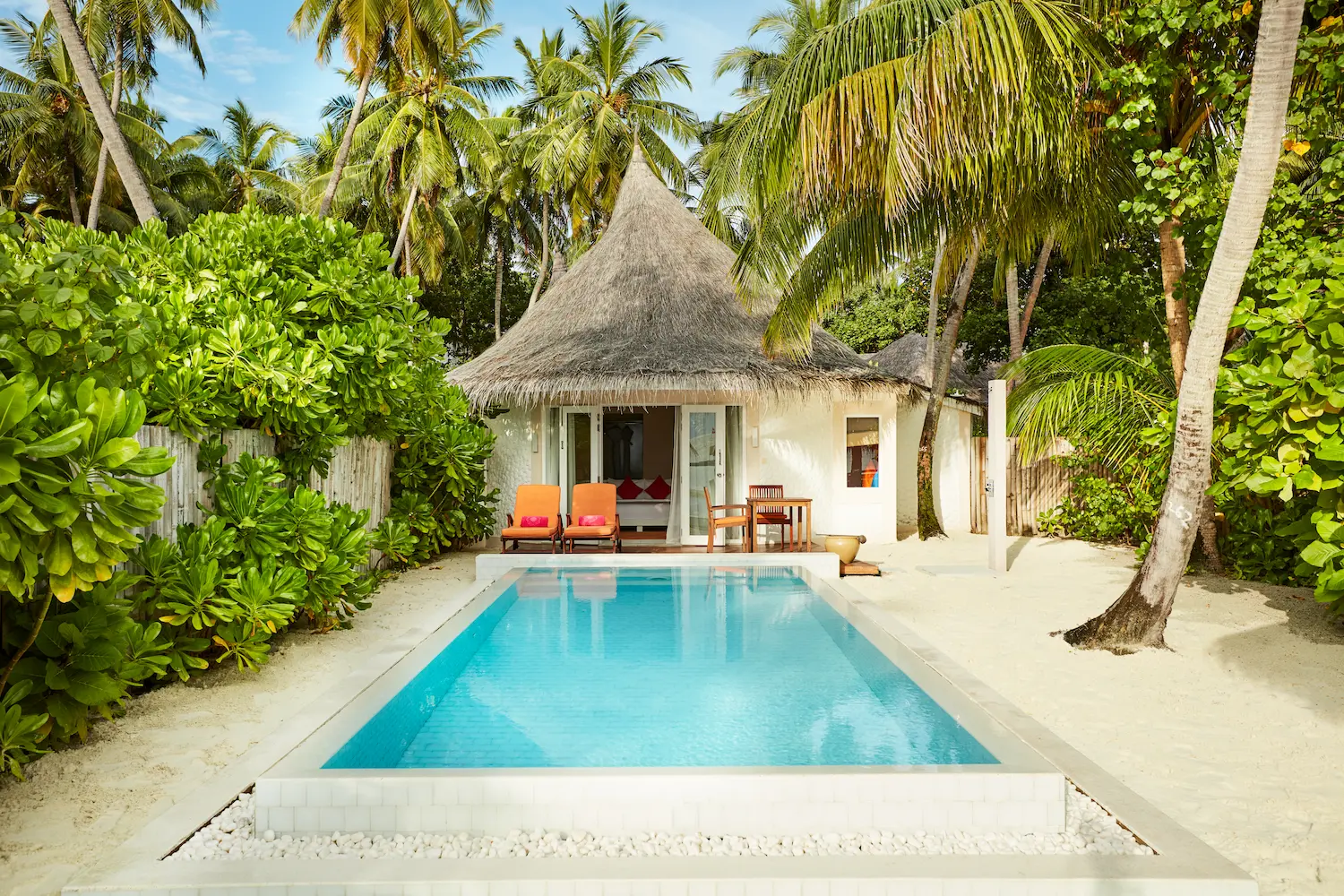 sun siyam vilu reef maldives beach villa with pool exterior set along a secluded white sand beach with lush tropical surroundings