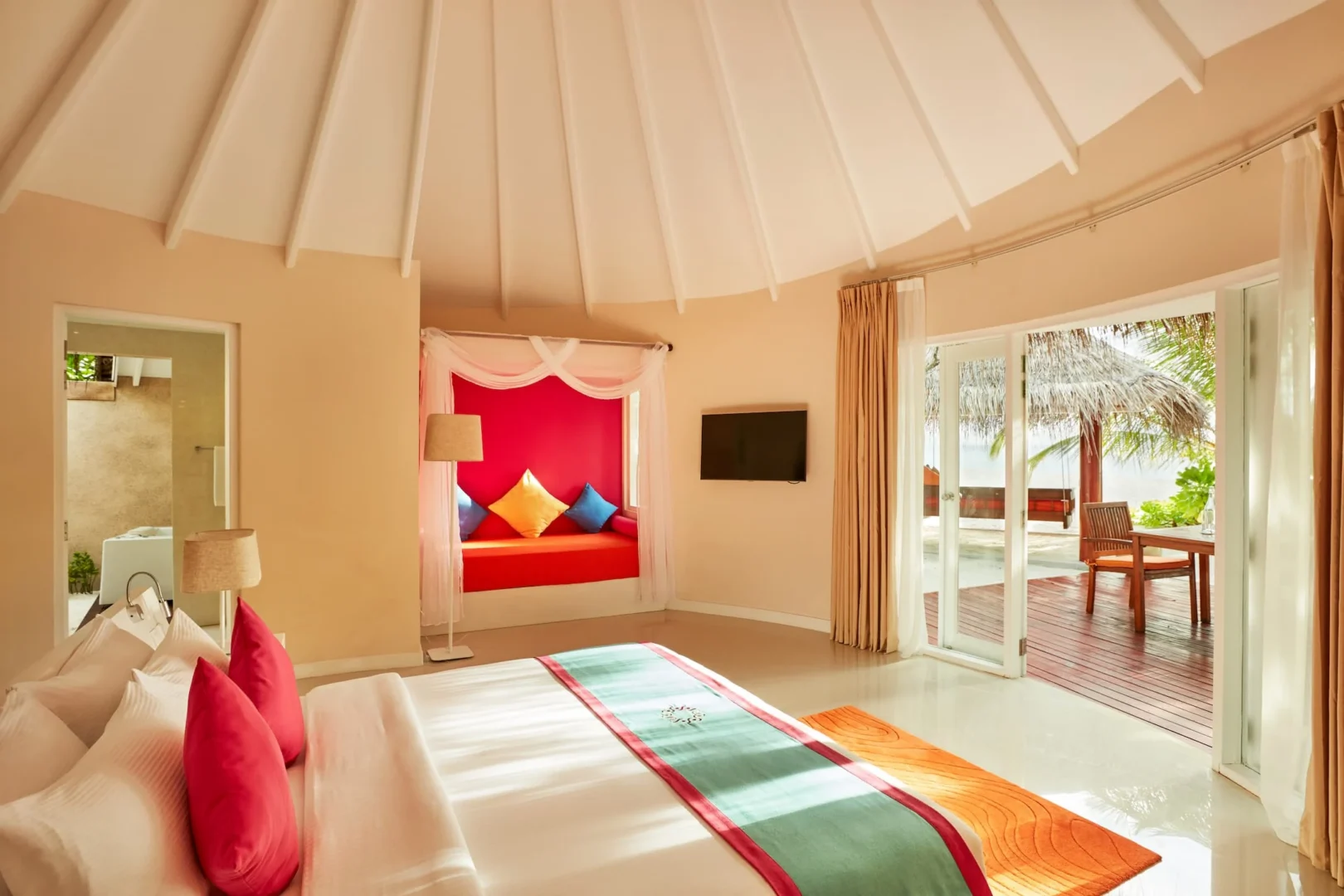 sun siyam vilu reef maldives deluxe beach villa bedroom featuring refined interiors natural light and a calm tropical ambience