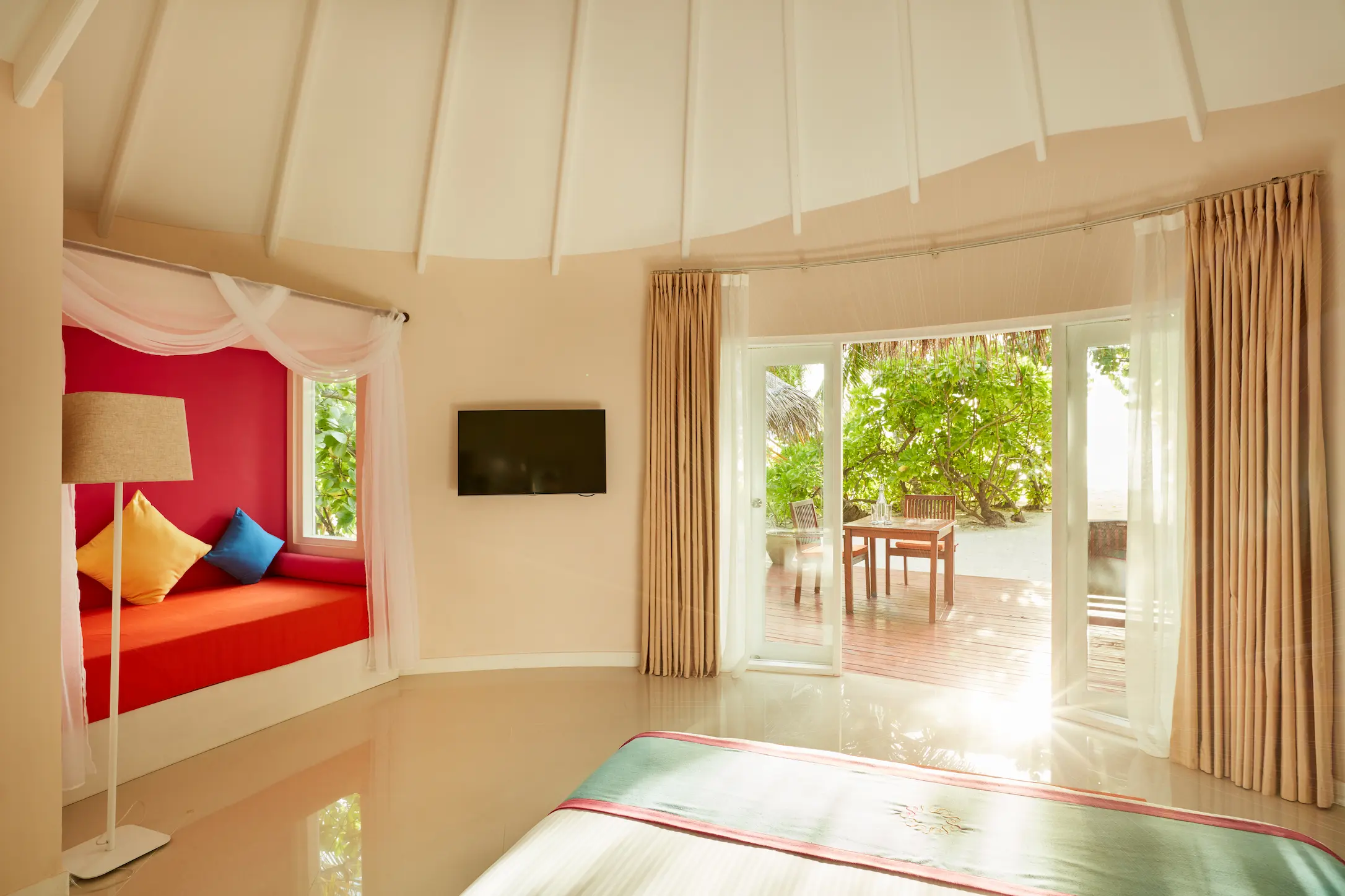 sun siyam vilu reef maldives deluxe beach villa bedroom view overlooking lush tropical surroundings and natural daylight