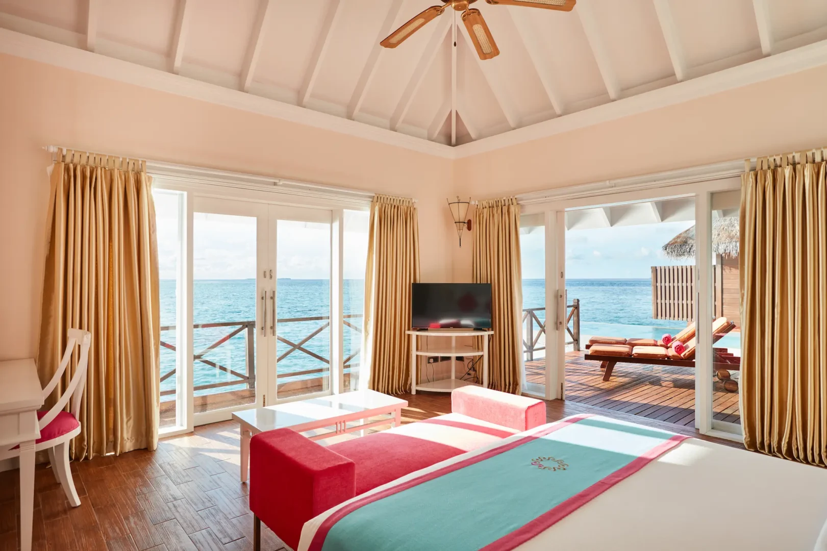 sun siyam vilu reef maldives grand water villa with pool bedroom featuring refined interiors natural light and tranquil overwater surroundings
