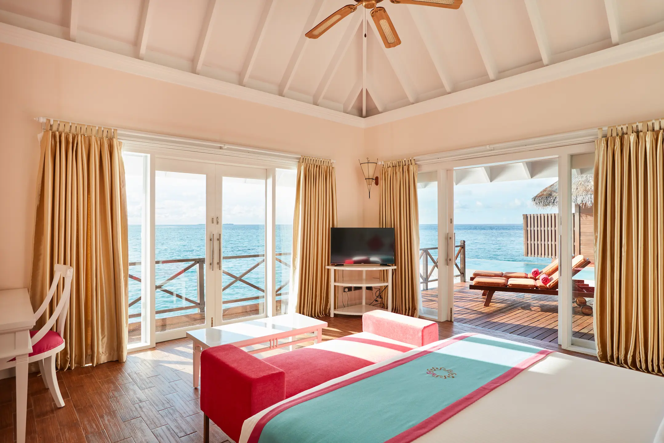 sun siyam vilu reef maldives grand water villa with pool bedroom featuring refined interiors natural light and tranquil overwater surroundings