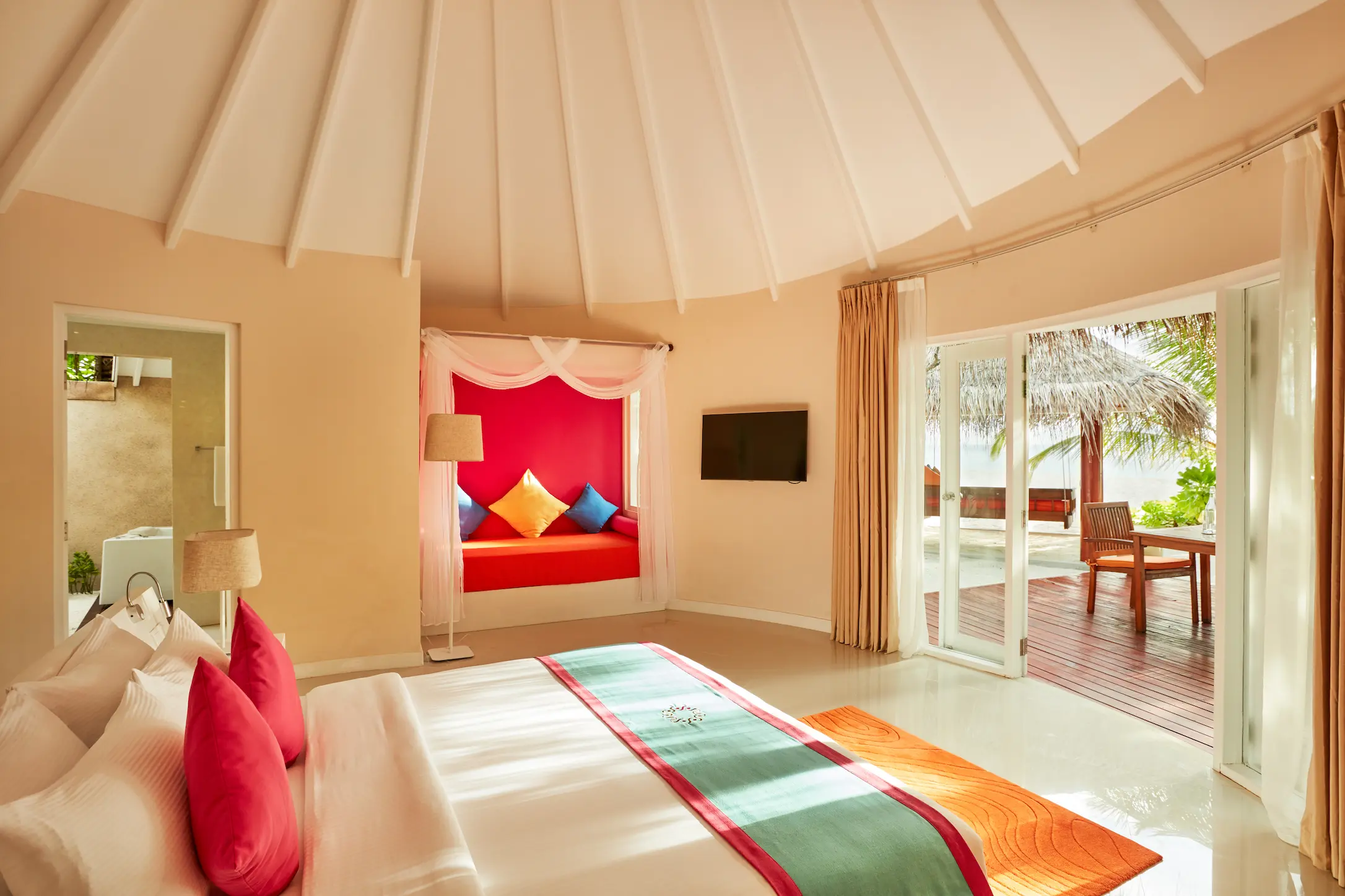 sun siyam vilu reef maldives jacuzzi deluxe beach villa bedroom featuring refined interiors natural light and a relaxed tropical ambience