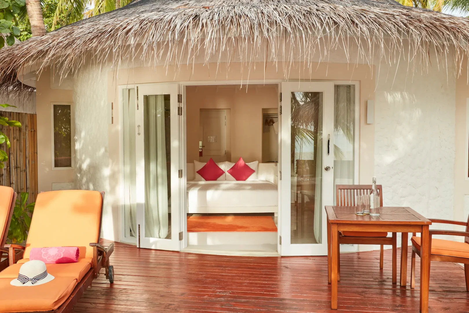 sun siyam vilu reef maldives jacuzzi deluxe beach villa terrace offering a private outdoor space surrounded by lush tropical greenery